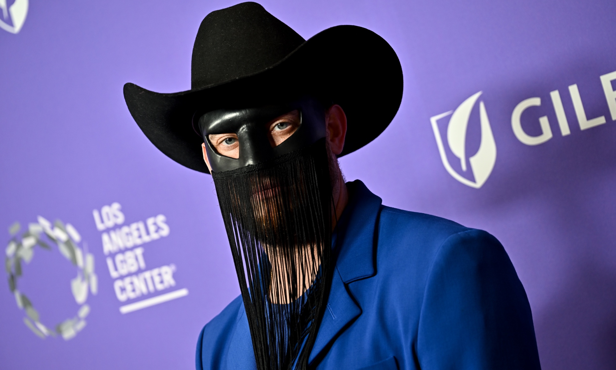 Gay country musician Orville Peck postpones tour citing mental and physical health reasons.