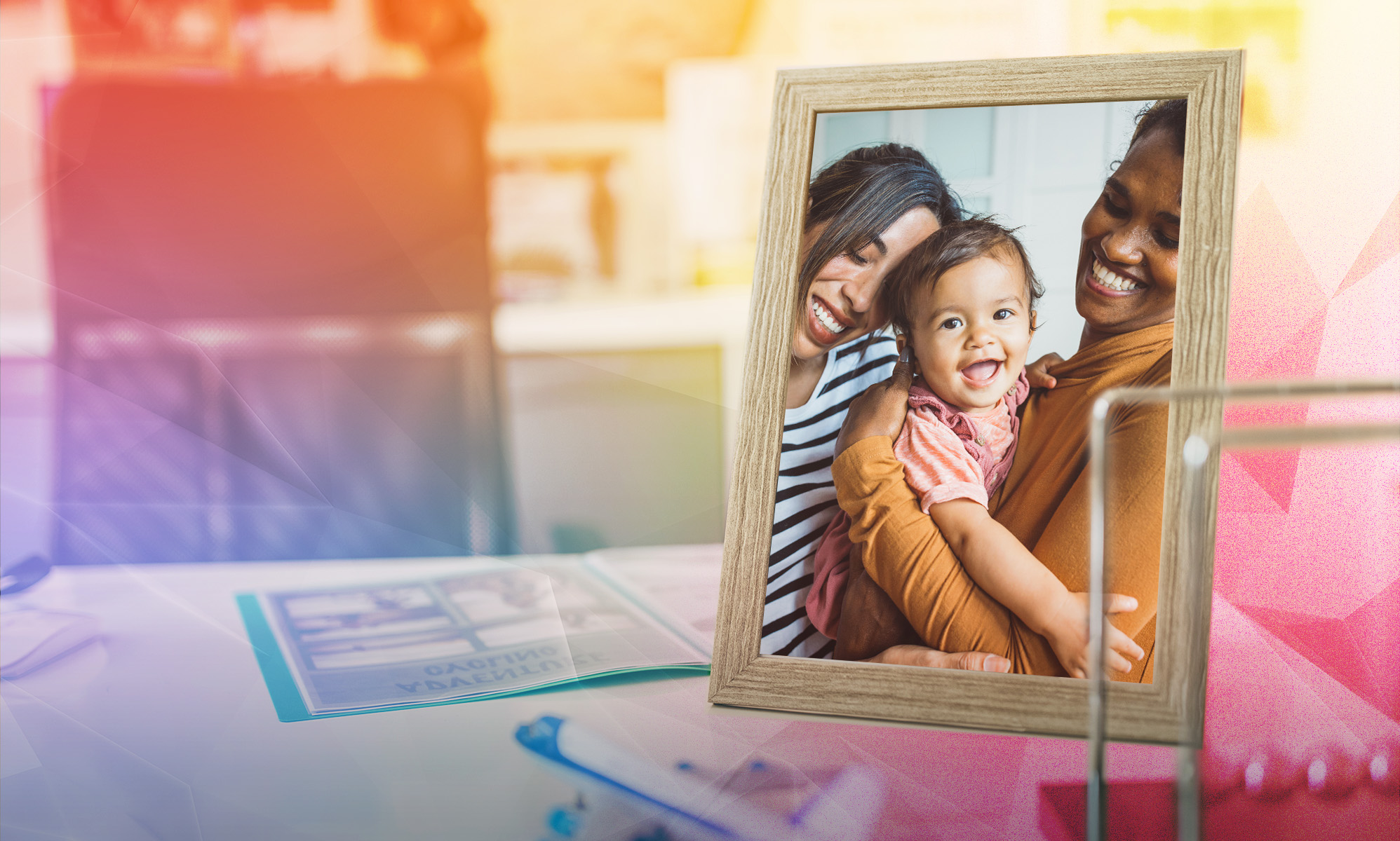 This is an image of an LGBTQ couple with their child in a picture frame. In the background is an office setup that is creatively overlayed with a prism.
