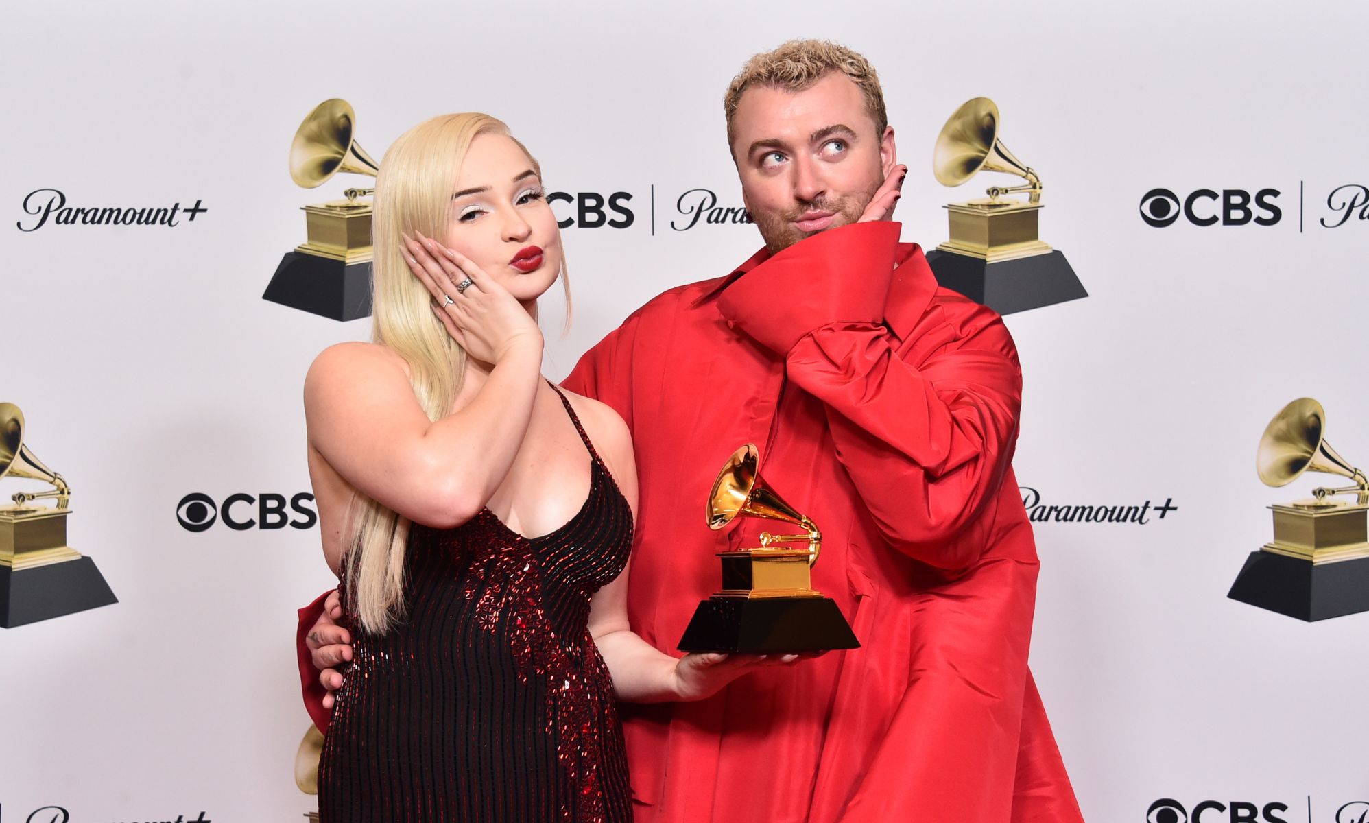 Kim Petras and Sam Smith pout and hold their Grammy award for