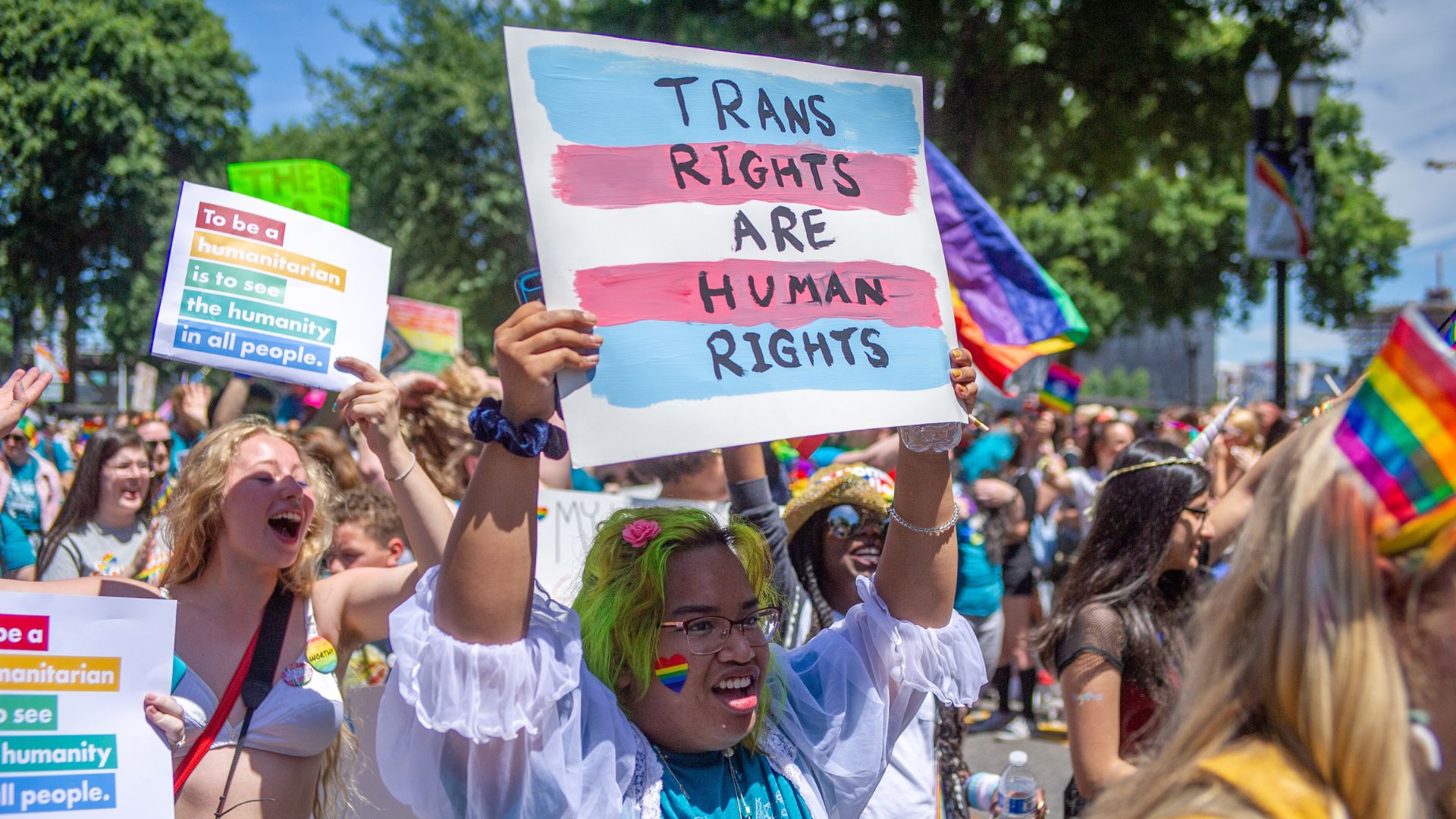 A person holds up a sign reading