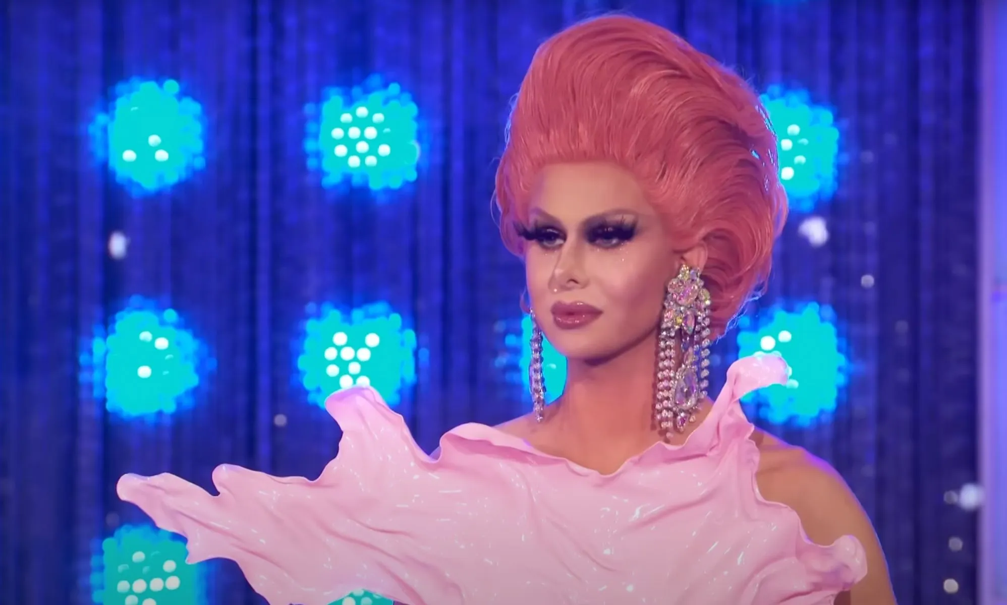 Trinity The Tuck in a plastic pink bodysuit and pink hair on All Stars 4.