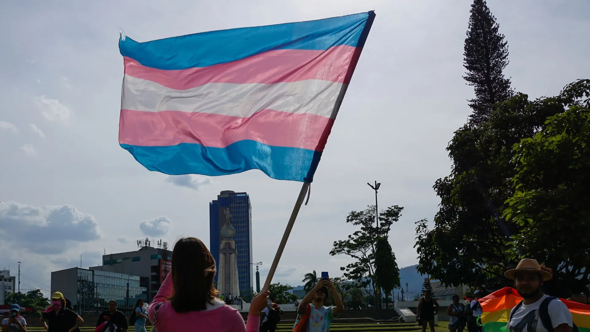 Activist holds trans flag on International Day Against Homophobia, Biphobia and Transphobia on May 20, 2023 in San Salvador, El Salvador