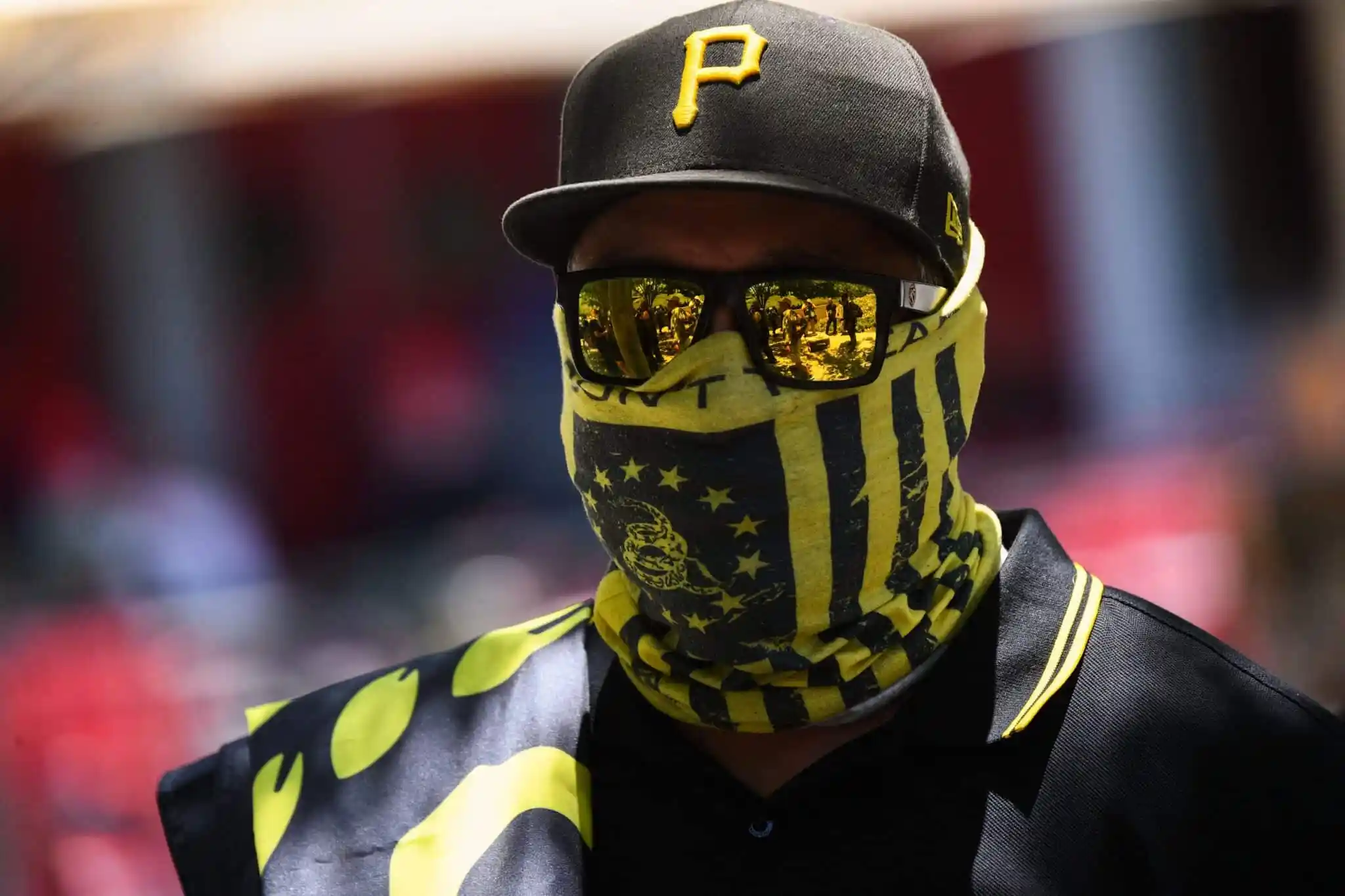 One of the members from the far-right group Proud Boys wearing a black and yellow bandana, cap and sunglasses