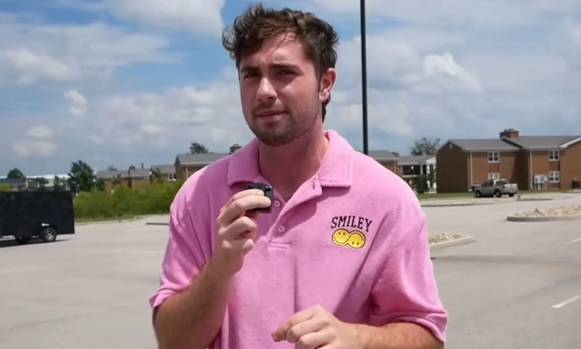 A picture of Bo Alford in a car park, wearing a pink shirt.