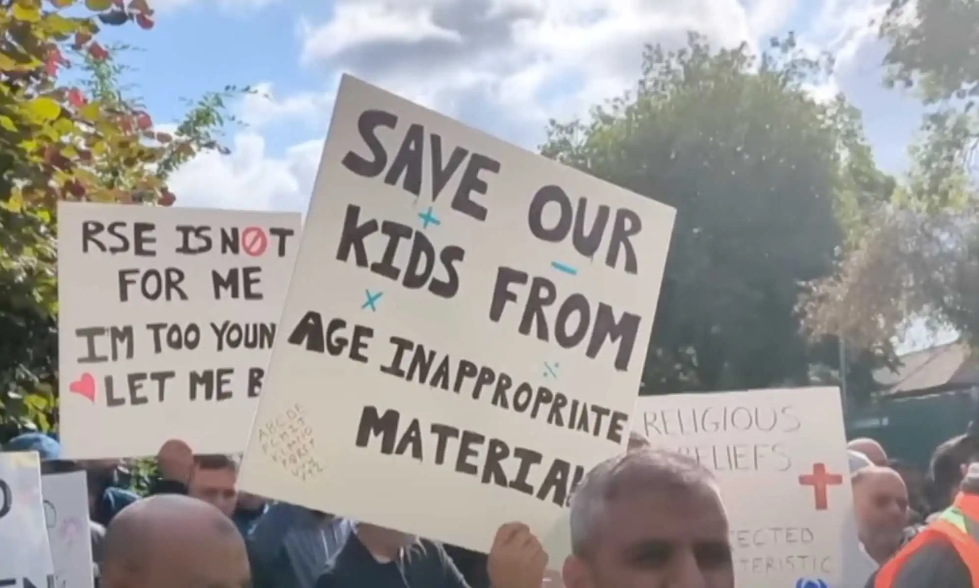Parents hold signs up at Birchfields Primary School protest in Manchester