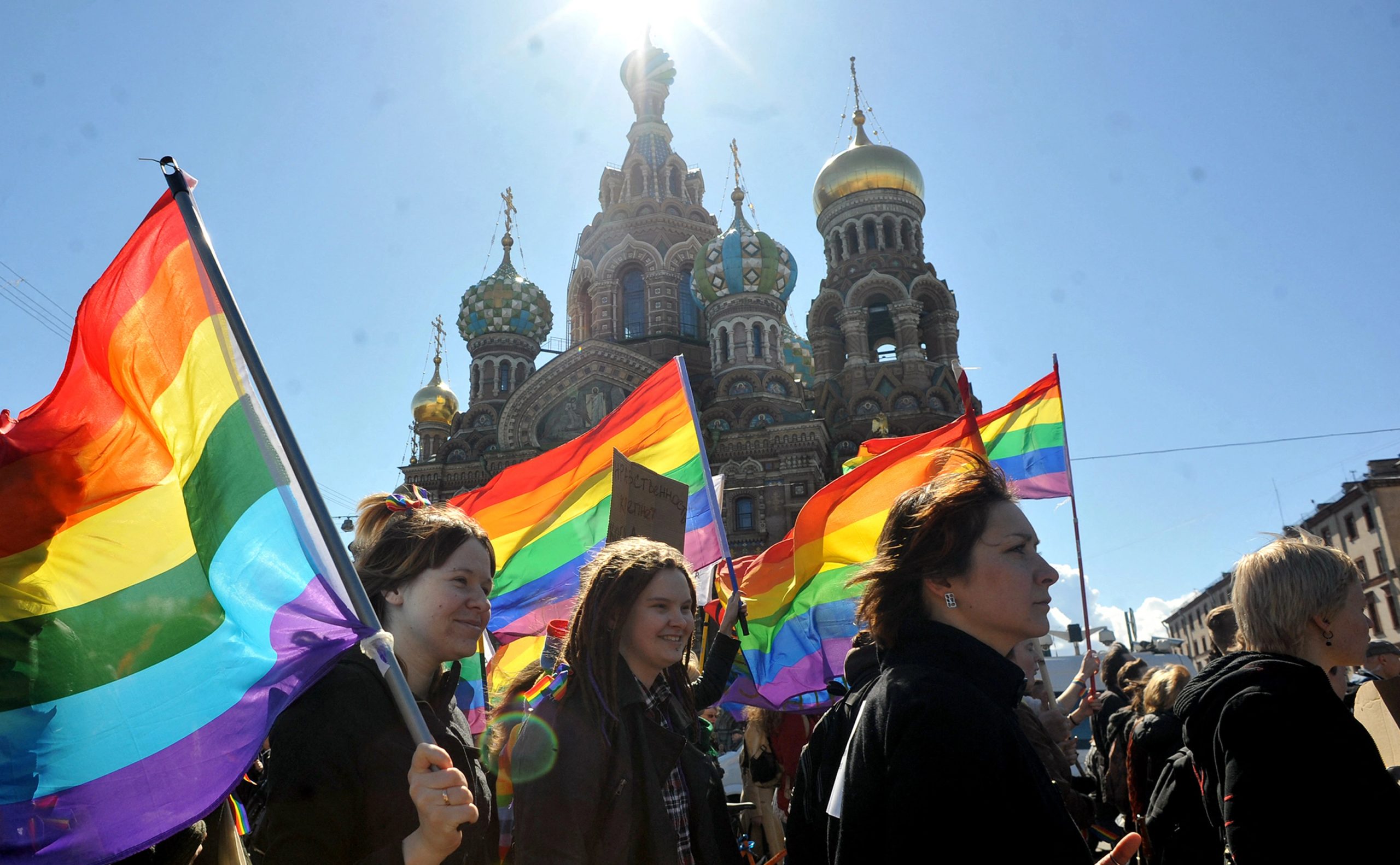 Several activists carry rainbow Pride flags in St Petersburg, Russia