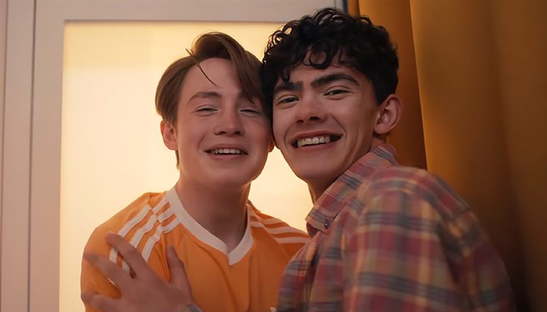 Kit Connor as Nick nelson (left) and Joe Locke as Charlie Spring (right), hugging in a photo booth. Heartstopper will conclude with Volume 6.