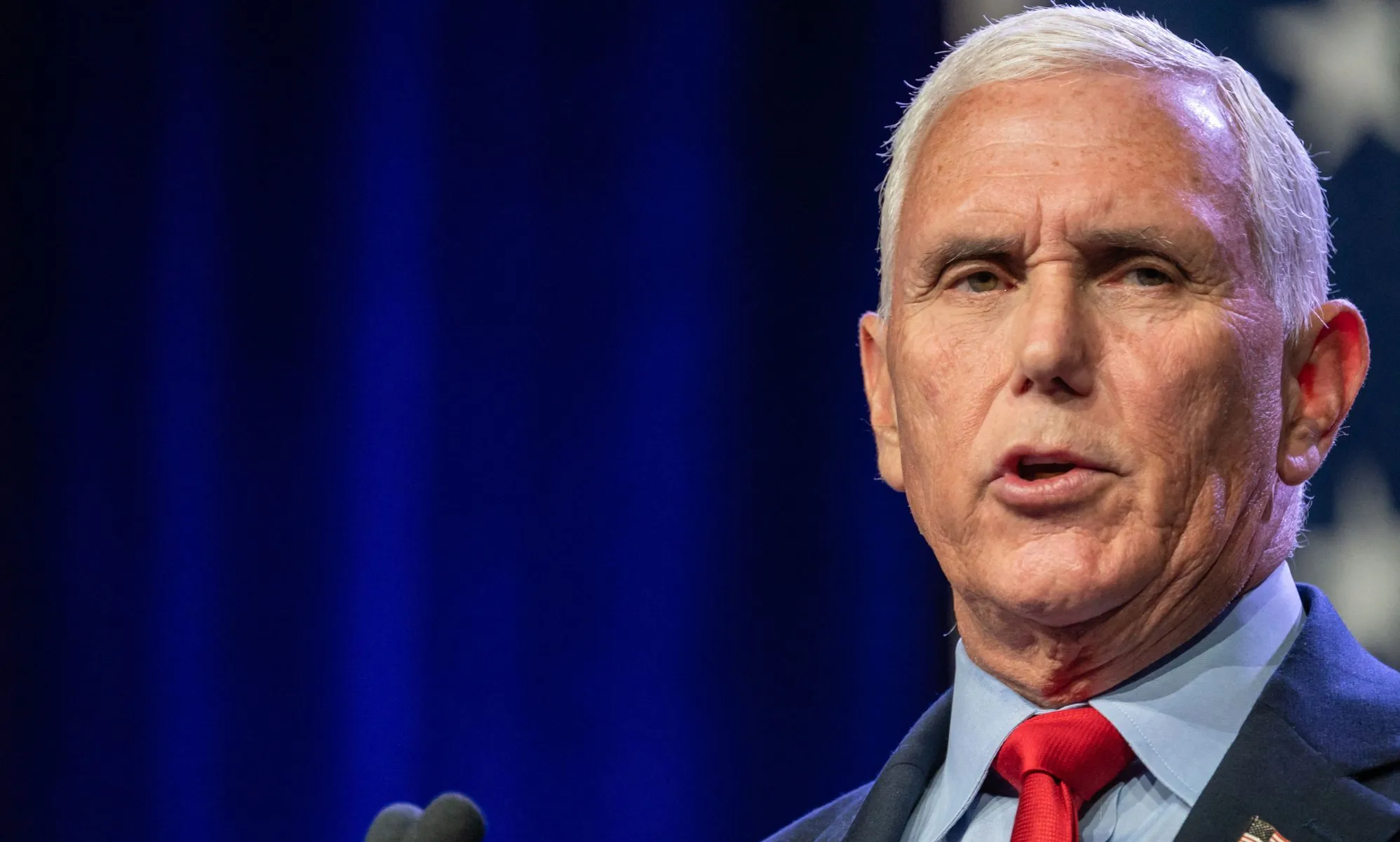 Republican presidential candidate Mike Pence, who has promised to bring back the trans military ban, wears a light blue shirt, red tie and dark jacket as he speaks at an event