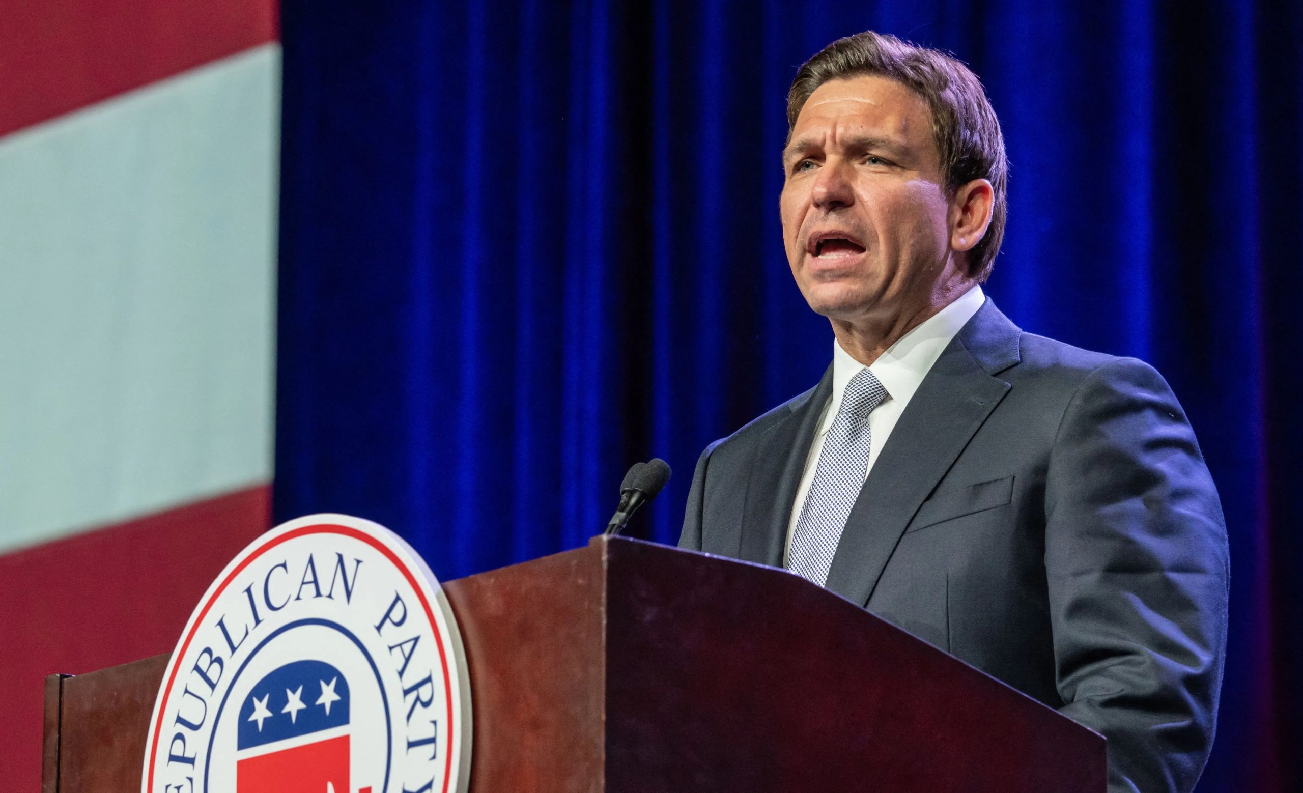 Florida governor Ron DeSantis stands at a podium