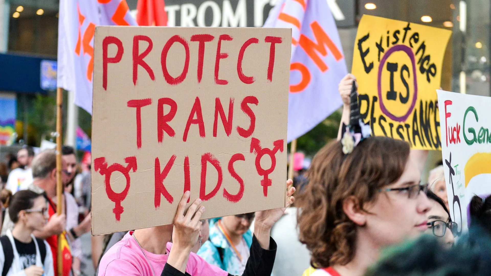 Protester holds up a sign reading