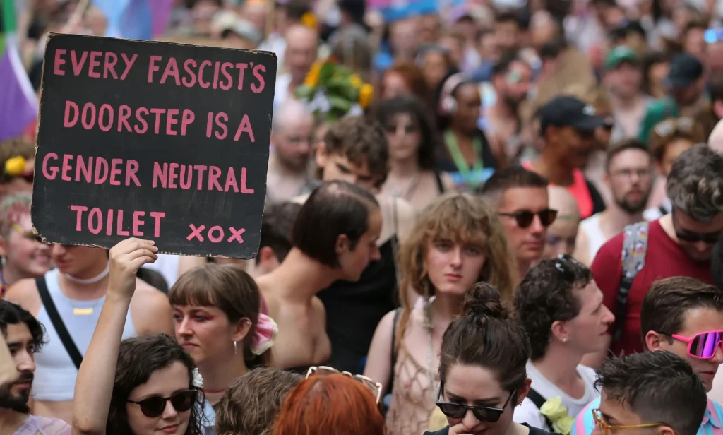 A person holds up a sign reading