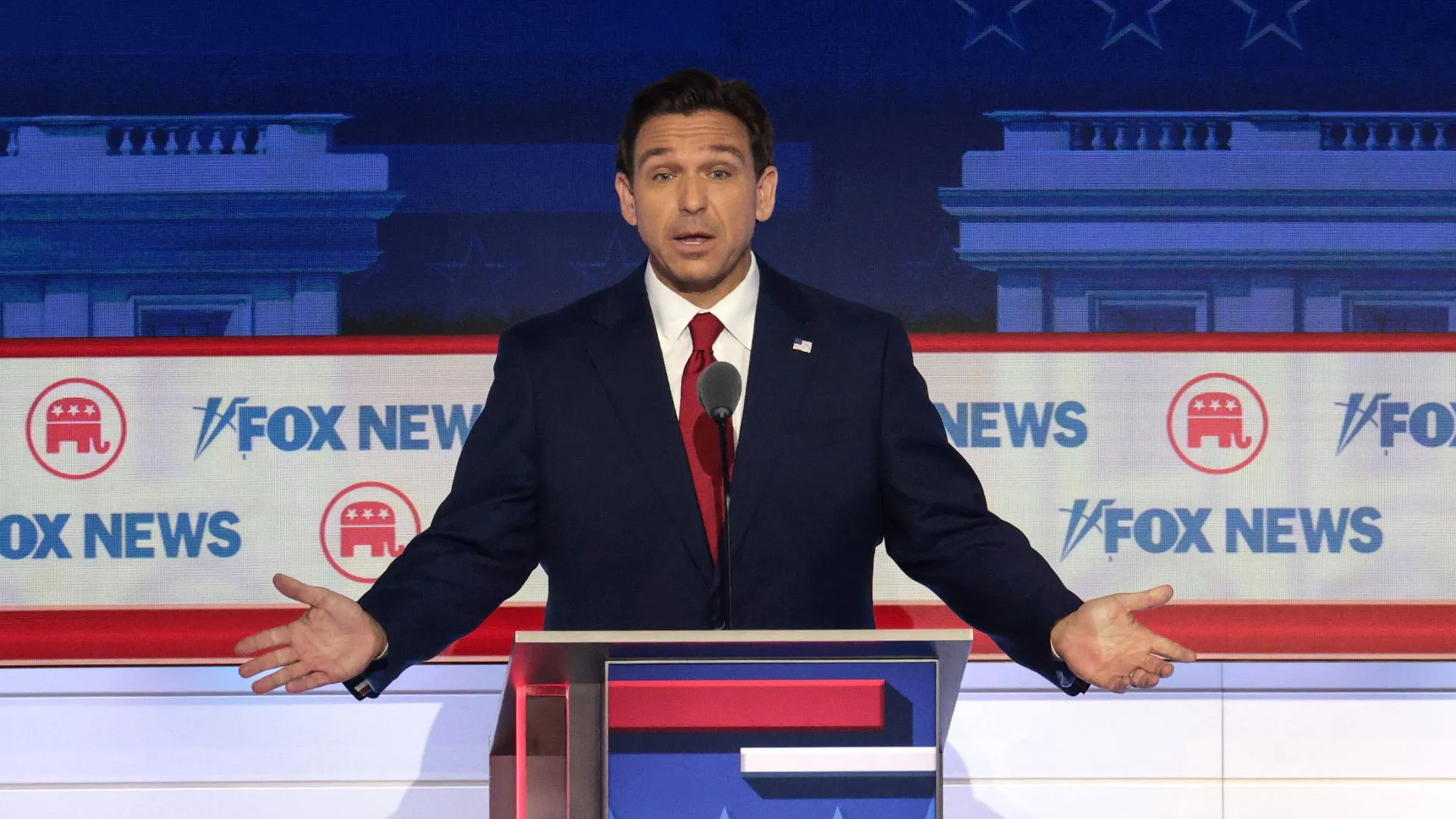Florida governor Ron DeSantis stands behind a podium during the Republican presidential debate 2024