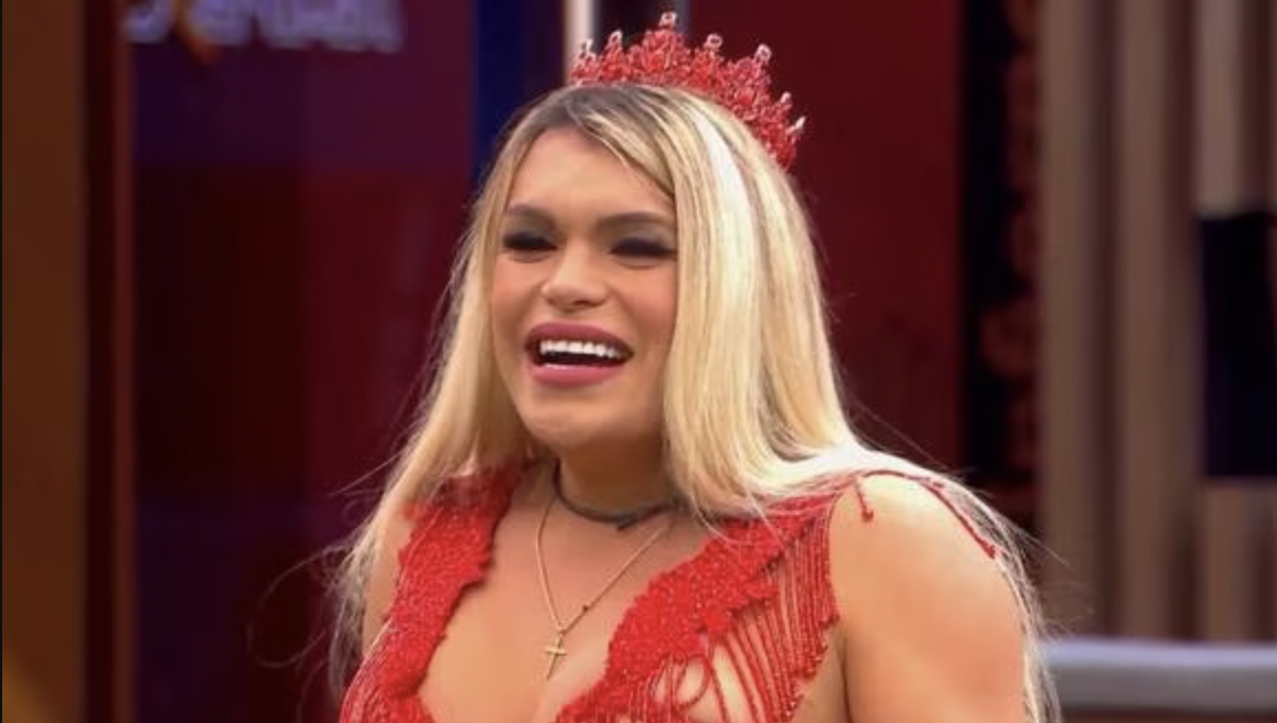 Wendy Guevara in a red top and crown.