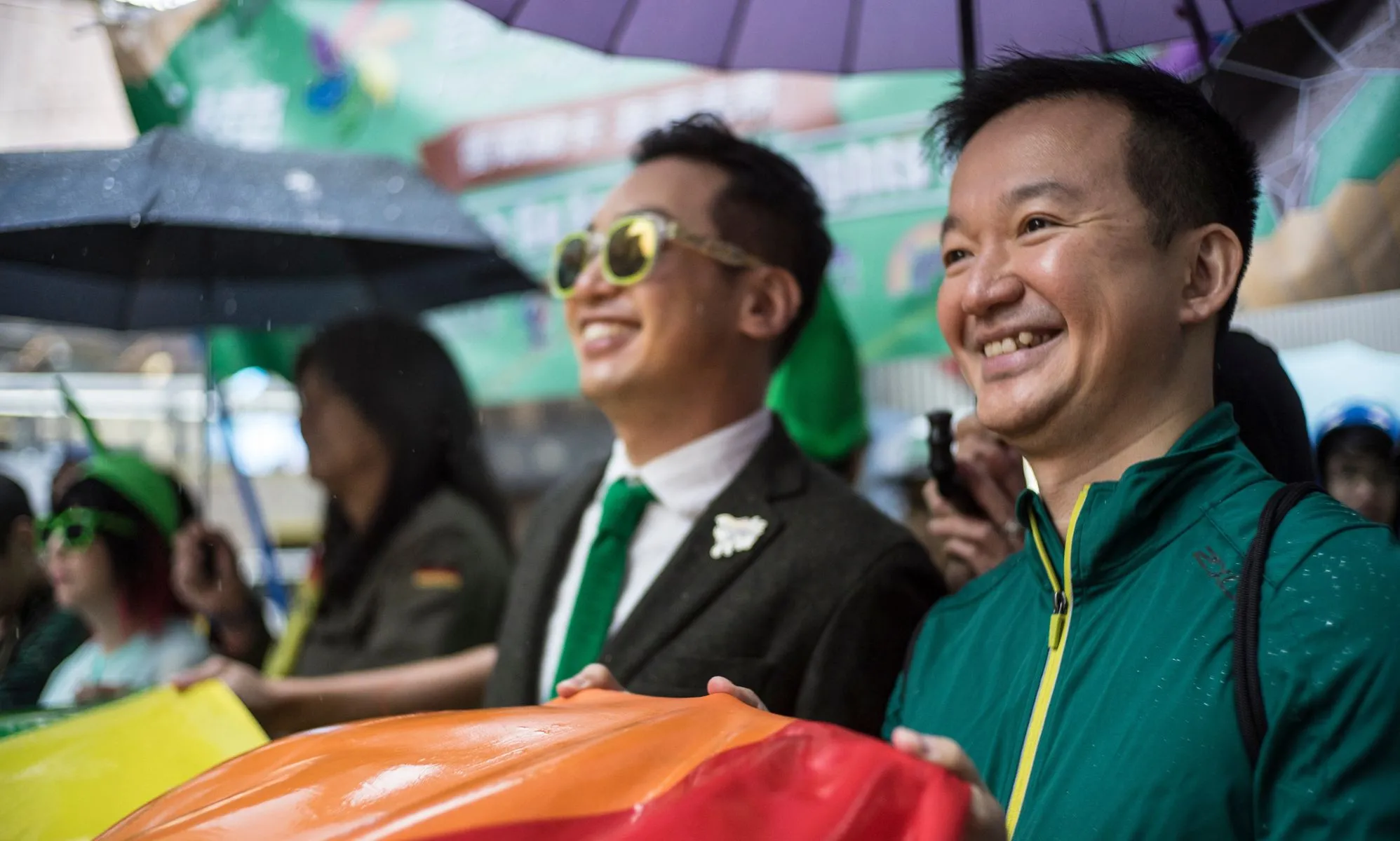 Two LGBTQ+ activists hold up a rainbow Pride flag during a protest in Hong Kong on queer rights, including recognition of same-sex partnerships and marriage equality
