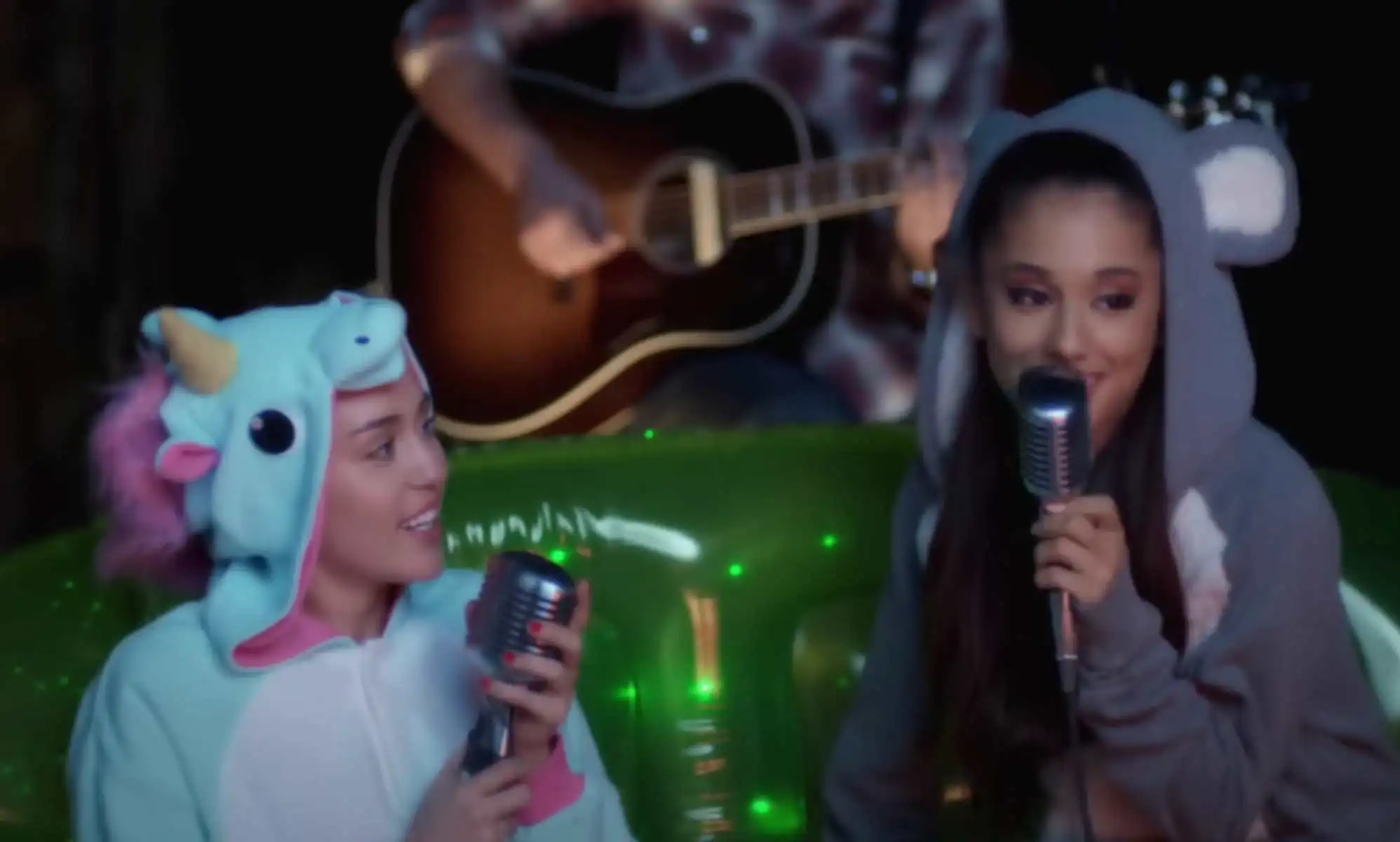 Miley Cyrus and Ariana Grande sing together.