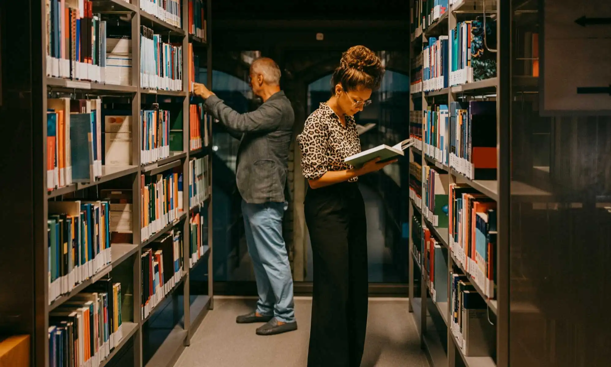 People looking at books in a library.