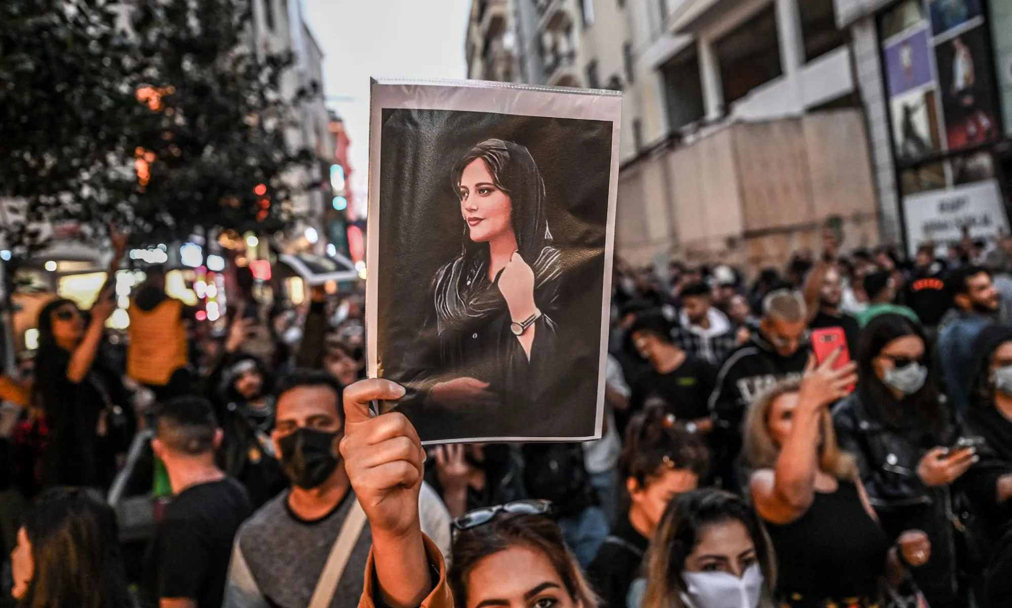 People gather together in protest one year after the death of Mahsa Amini, a Kurdish-Iranian woman who died in the custody of Iran