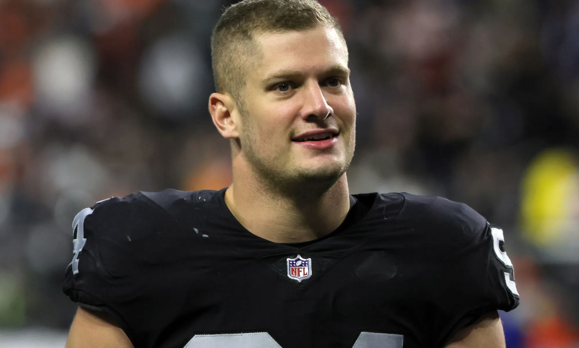Carl Nassib wearing a football jersey on the pitch.