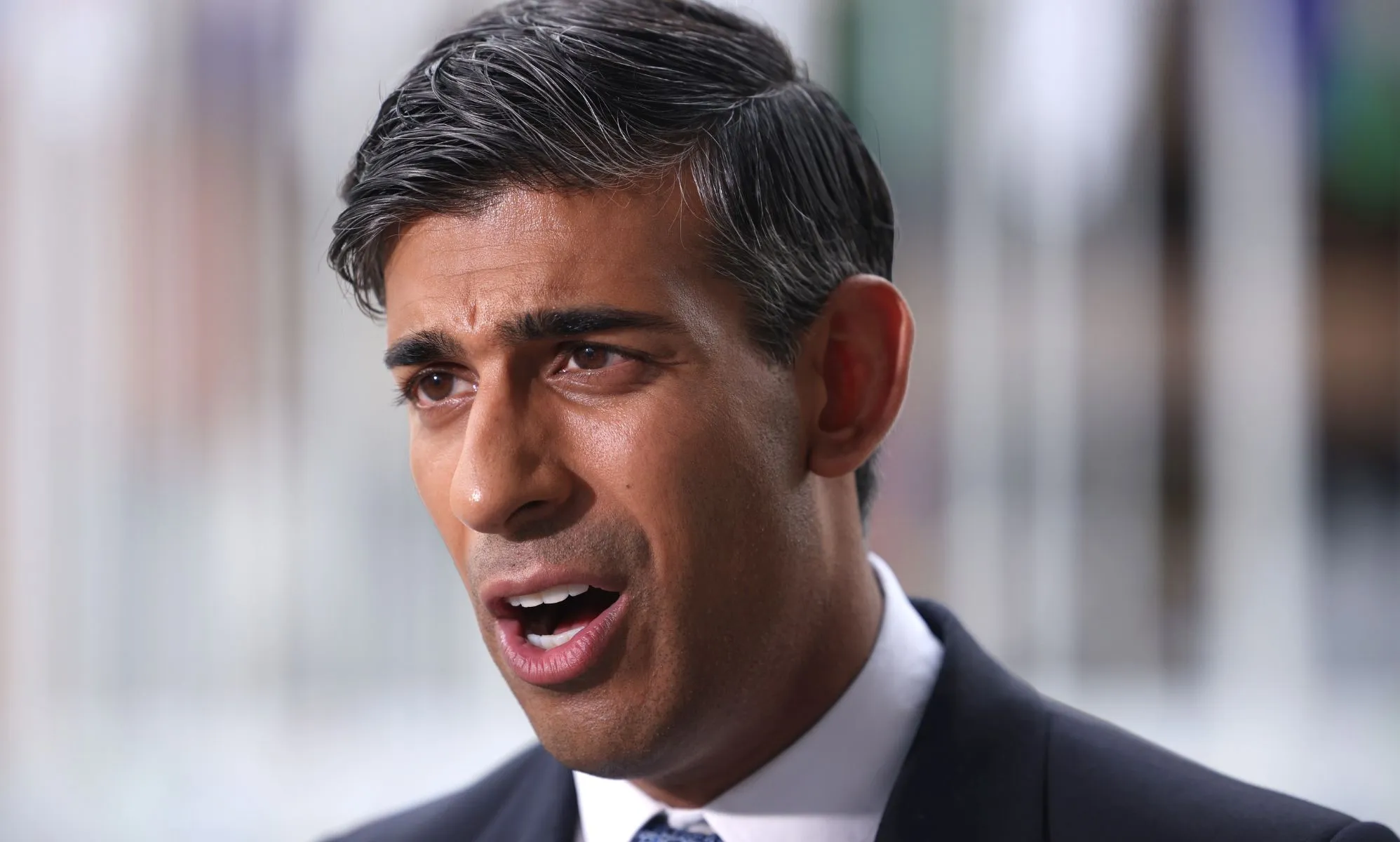 Rishi Sunak speaking at a conference.