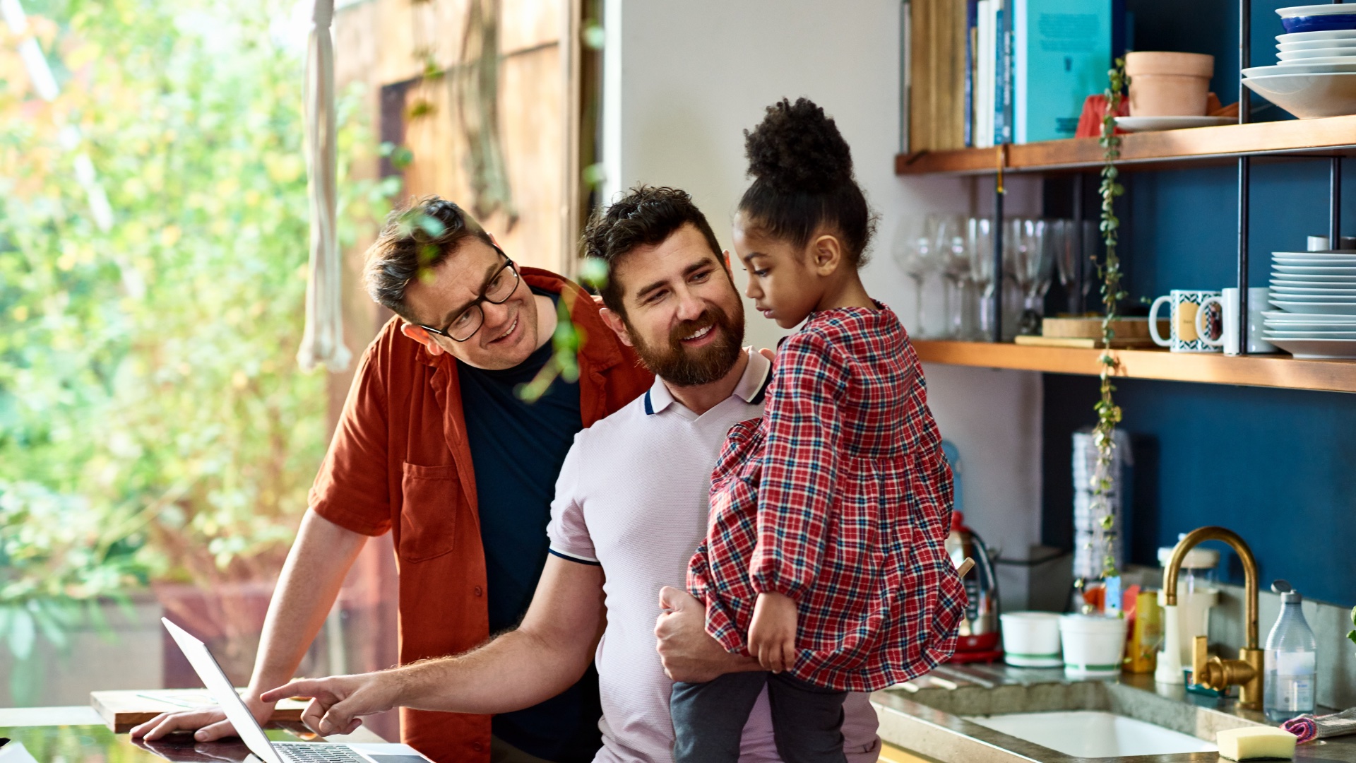 Family of two dads and one child, to illustrate a story about foster care