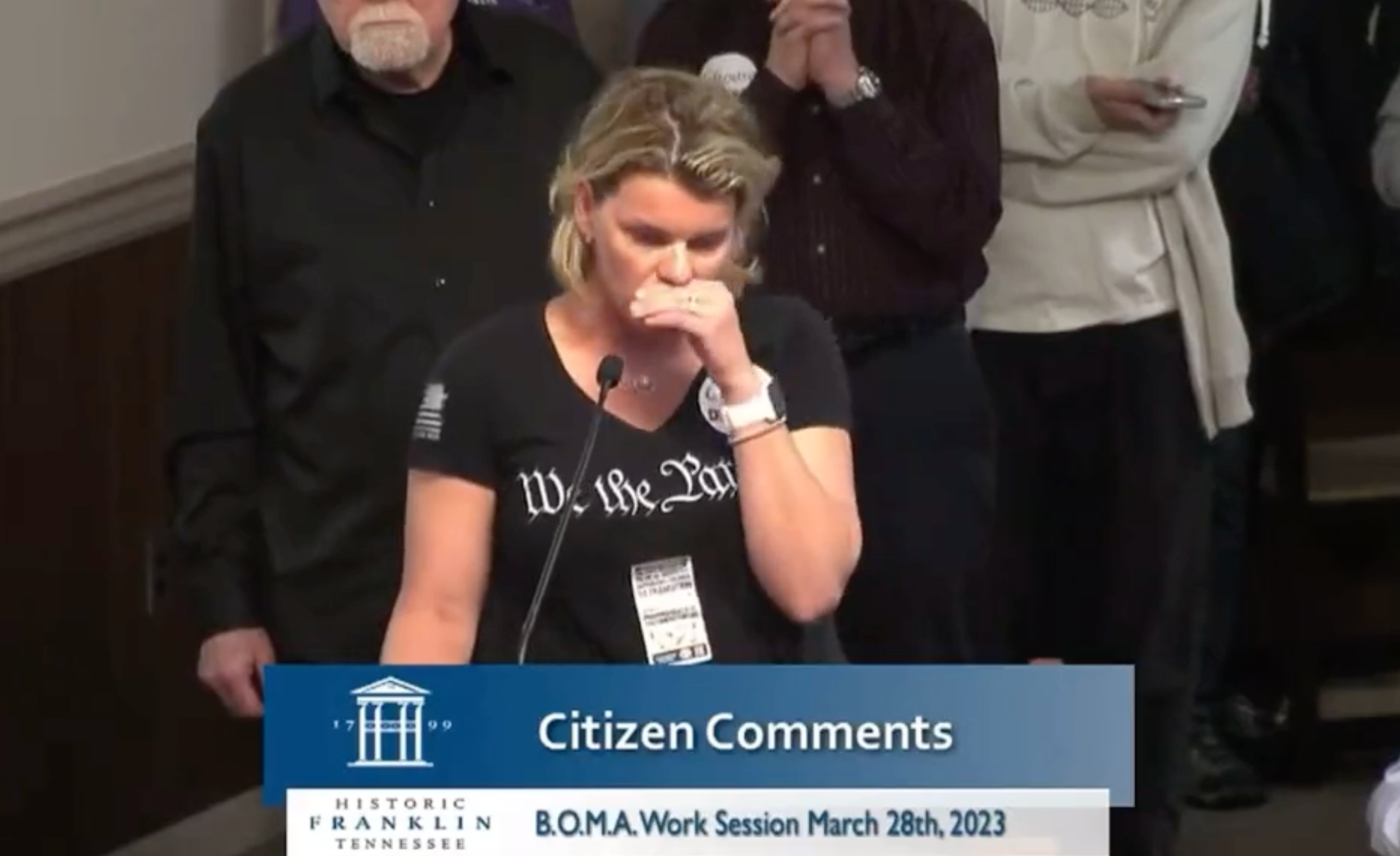 Republican Erin Mazzoni tears up as she gives a speech in front of the Franklin Board of Mayor and Aldermen