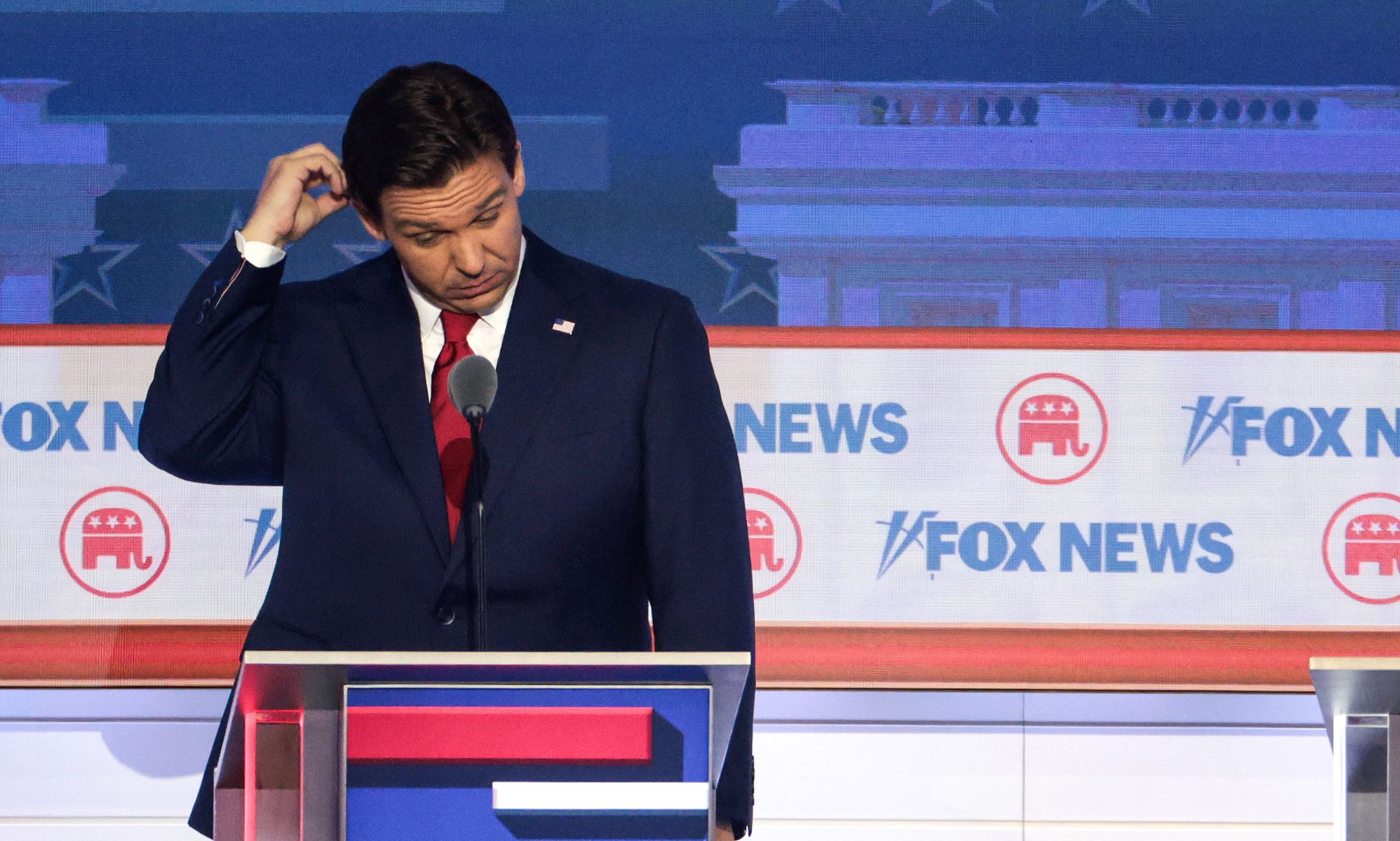 Ron DeSantis scratches his head on stage at the Republic National debate.