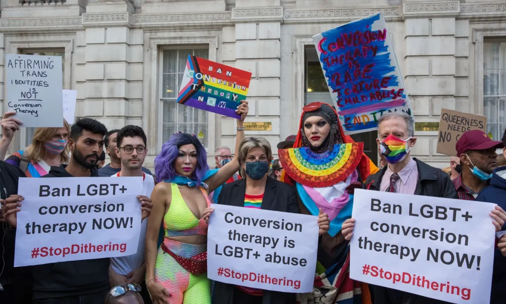People hold up signs reading