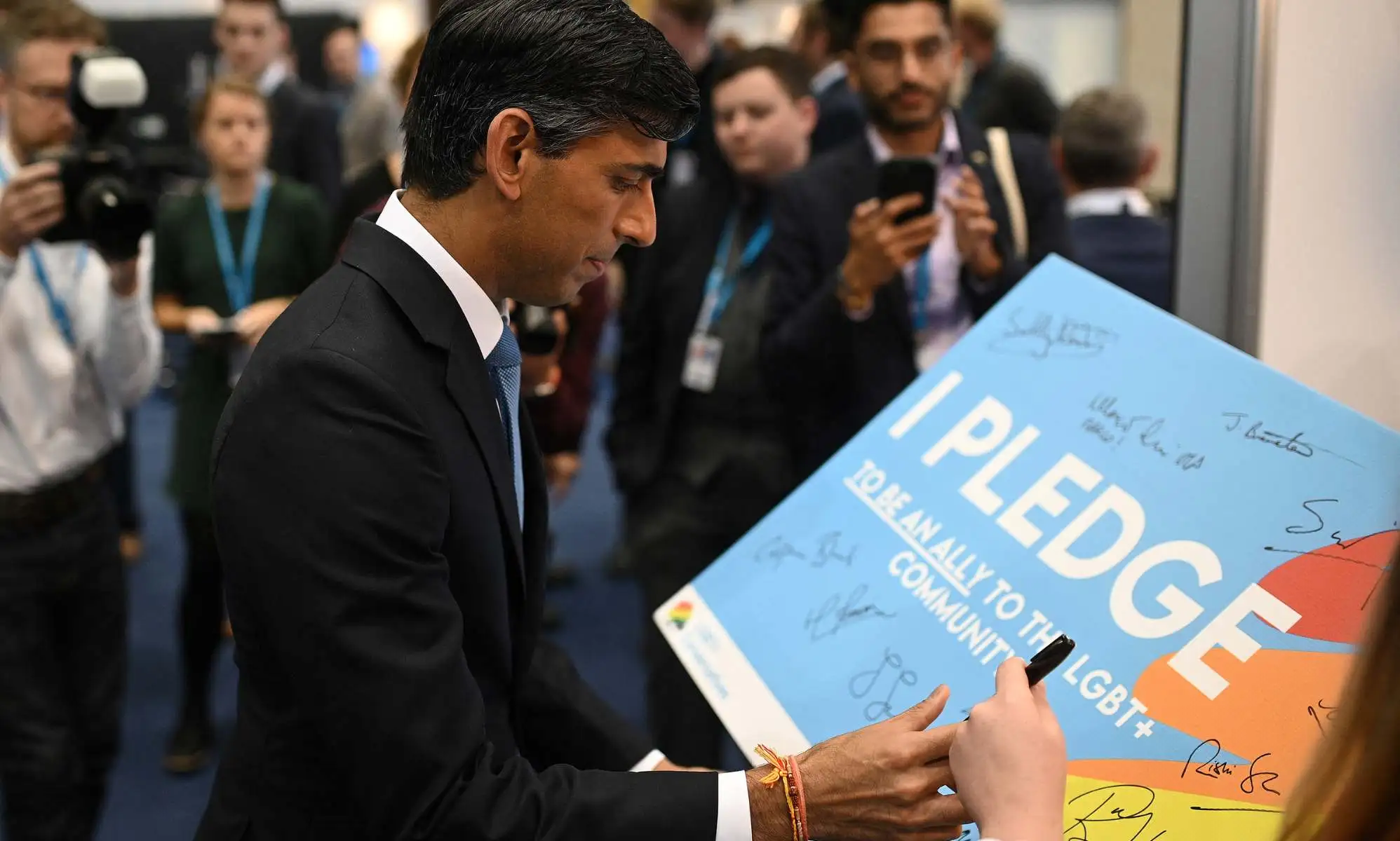 Rishi Sunak signing a pledge with LGBT+ Conservatives.