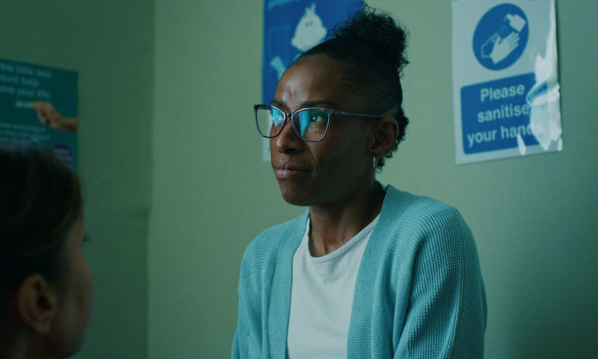 A still from the Terrence Higgins Trust advert in which a woman looks discouraged in a hospital room.