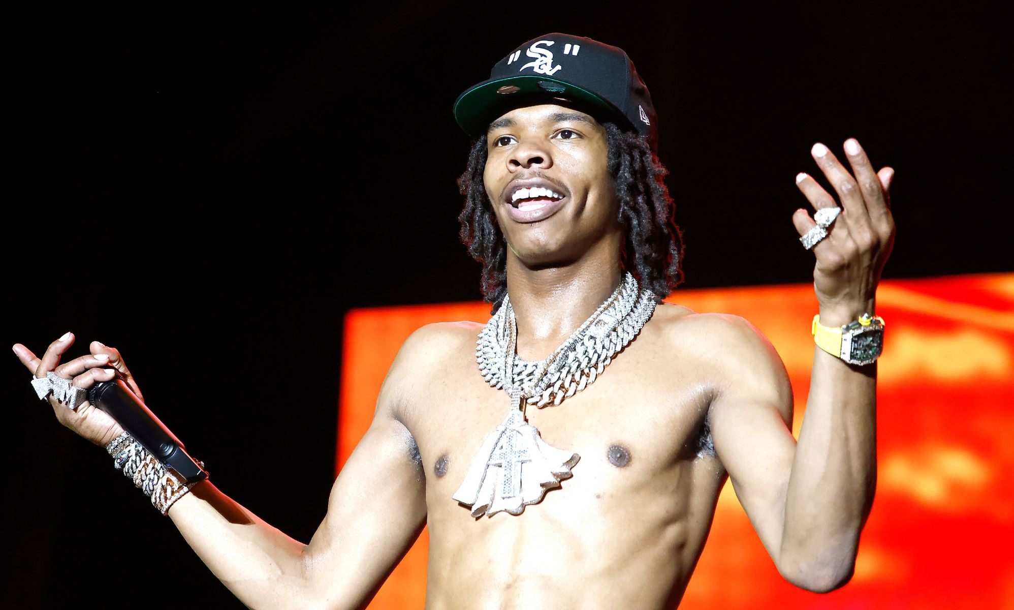 Lil Baby performs topless at 2022 Something In The Water Music Festival.
