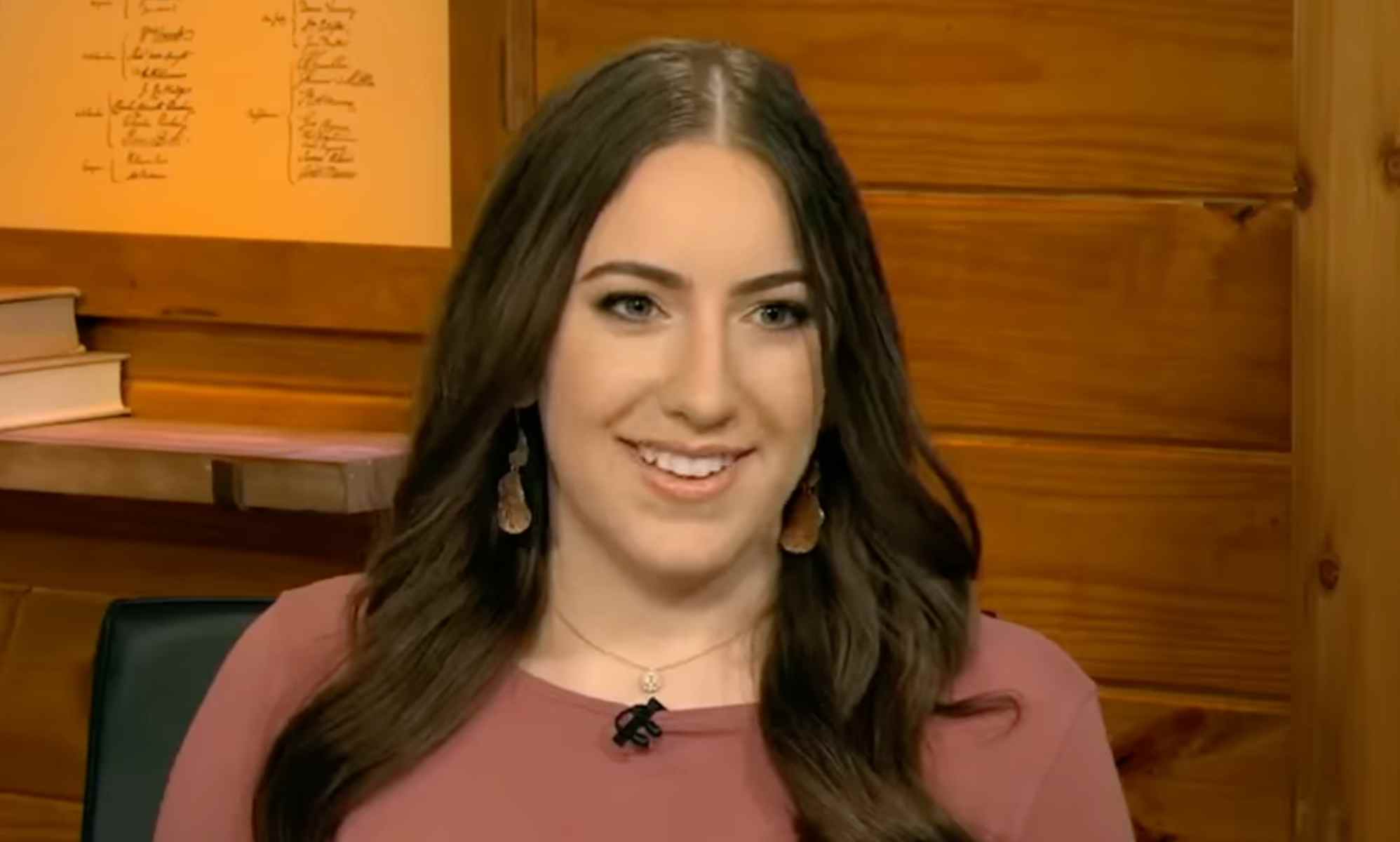 A still of Chaya Raichik, LibsOfTikTok founder, on Fox New wearing a pink top and smiling