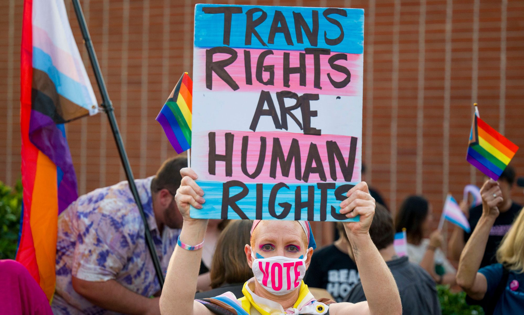 Protester holds up sign reading