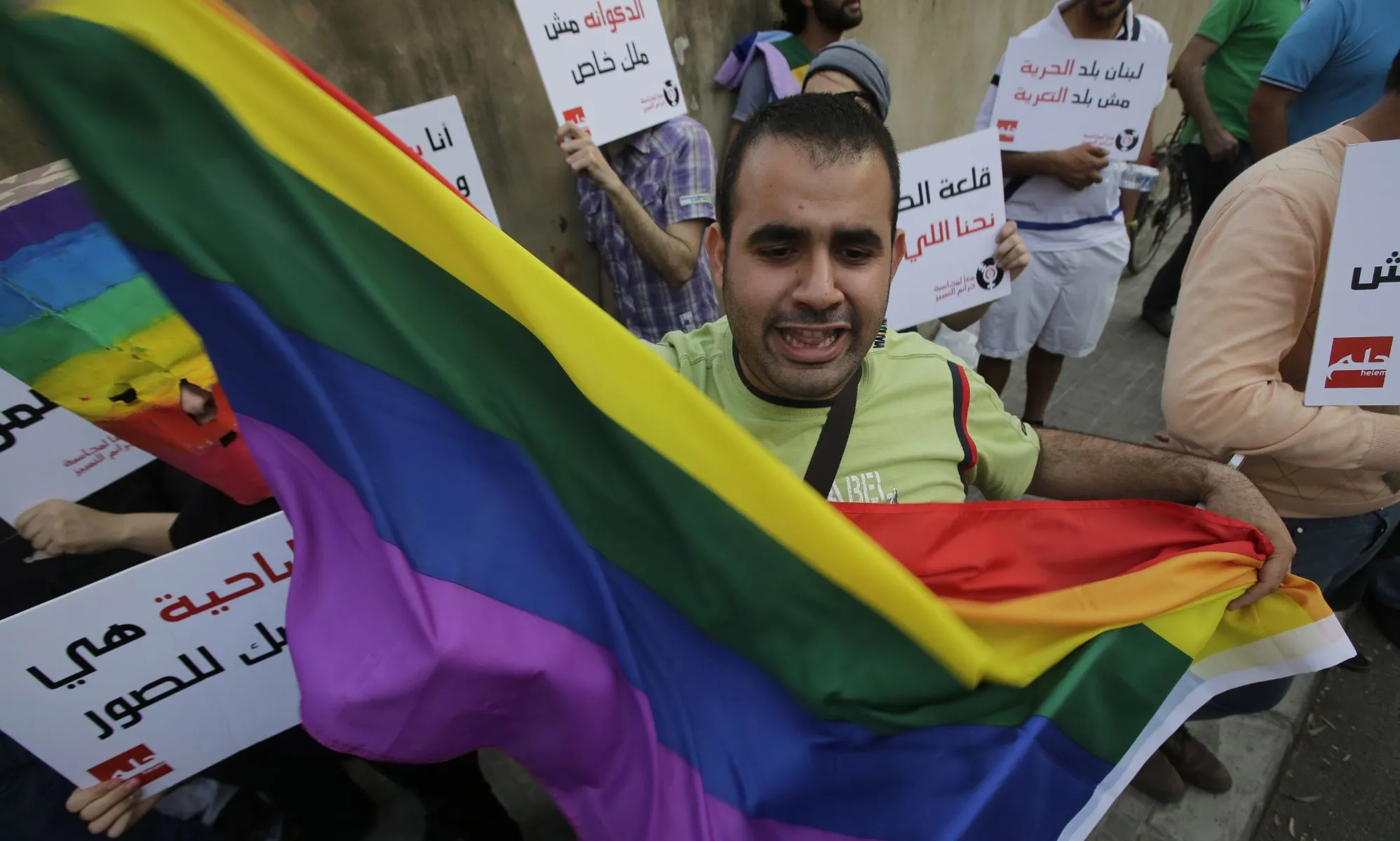 A protestor waves a Pride flag during an anti-homophobia rally in Beirut on 30 April 2013