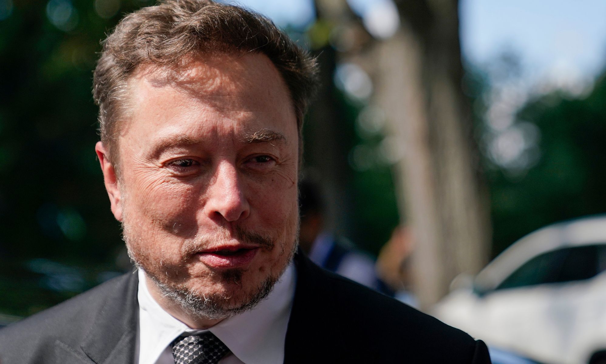 X/Twitter owner Elon Musk talking to press.