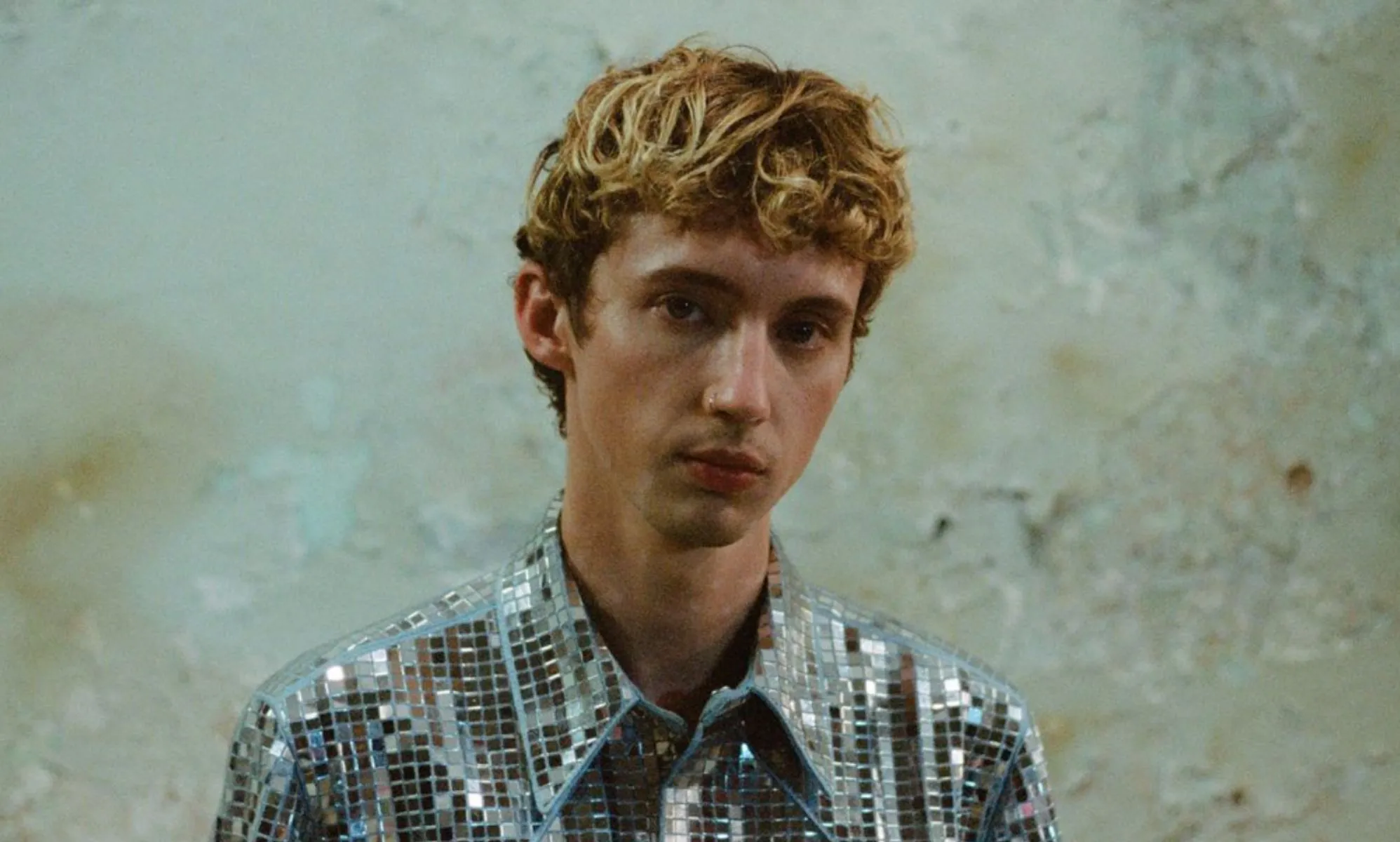 Troye Sivan in a silver top.