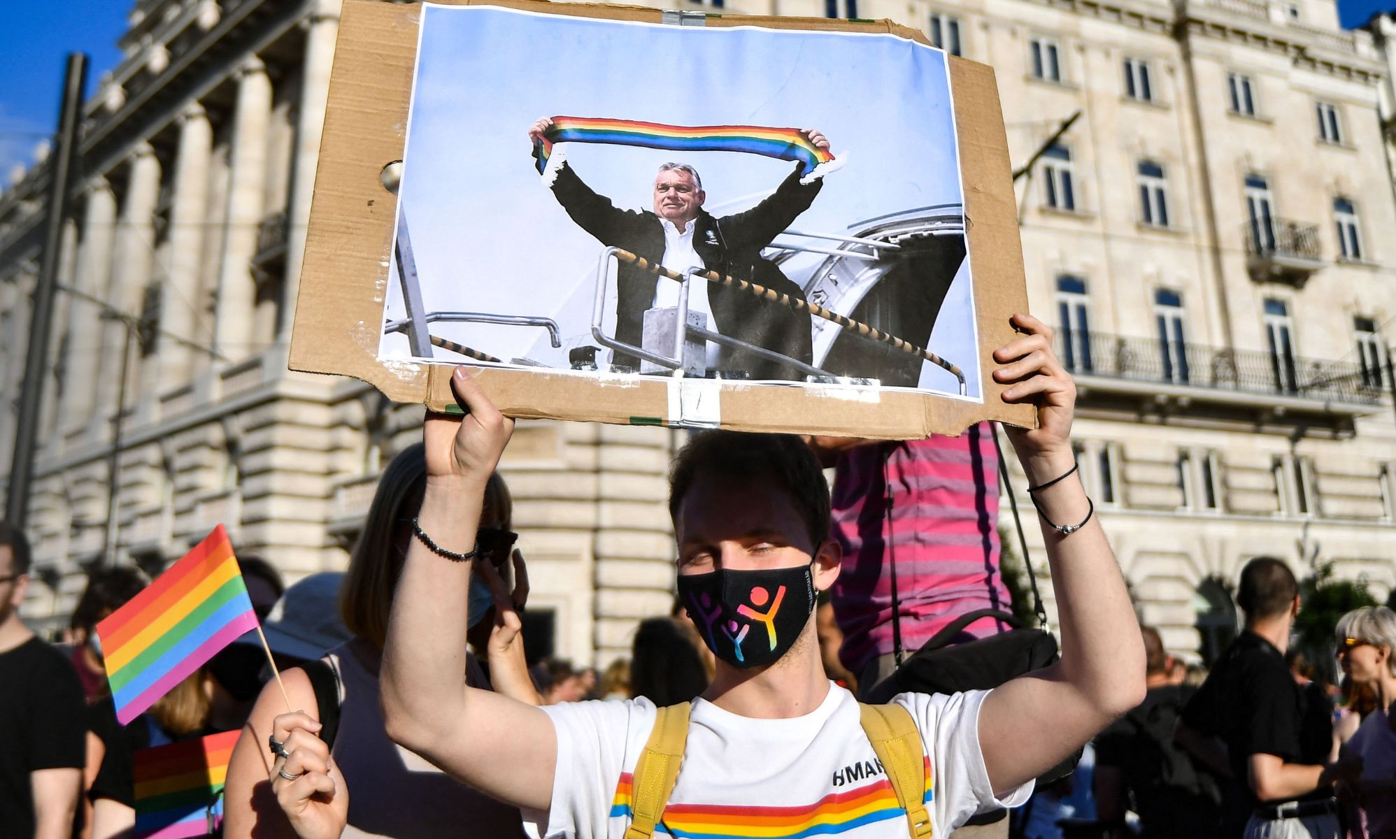 A person holds up a sign of Hungary