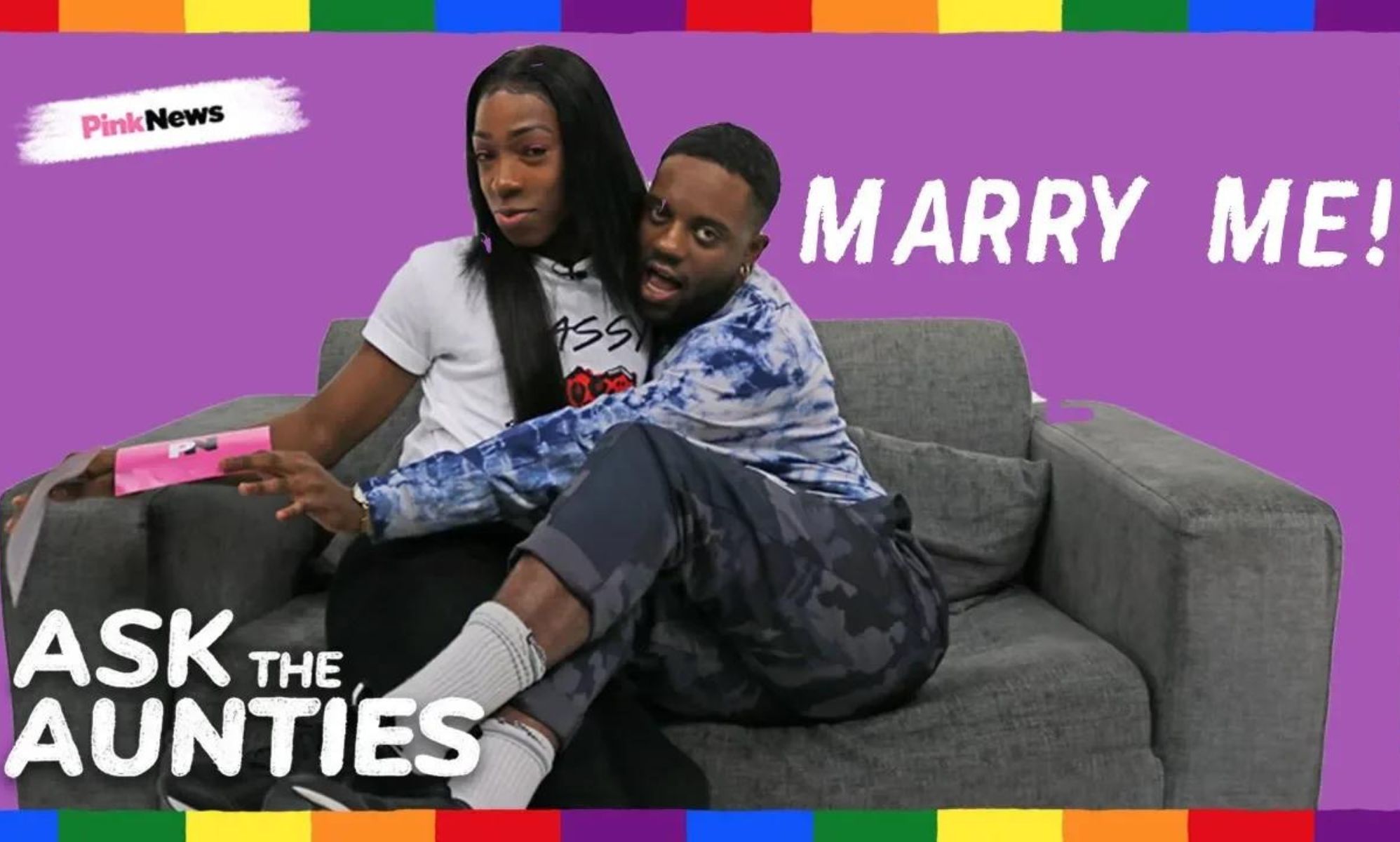 This is an image of two Black men sitting on a couch with a purple background behind them. In text reads