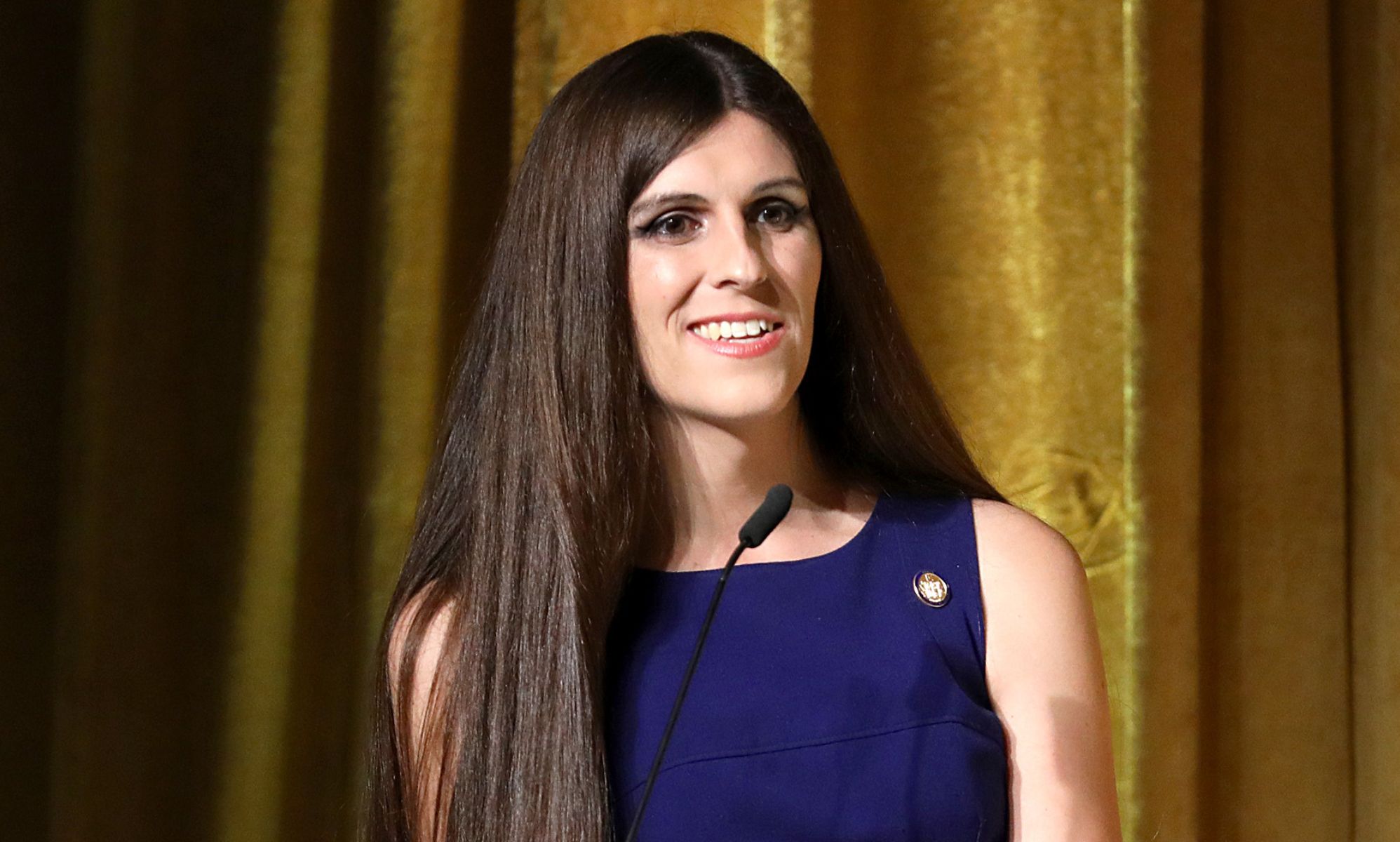Danica Roem smiling on the stage of an event.