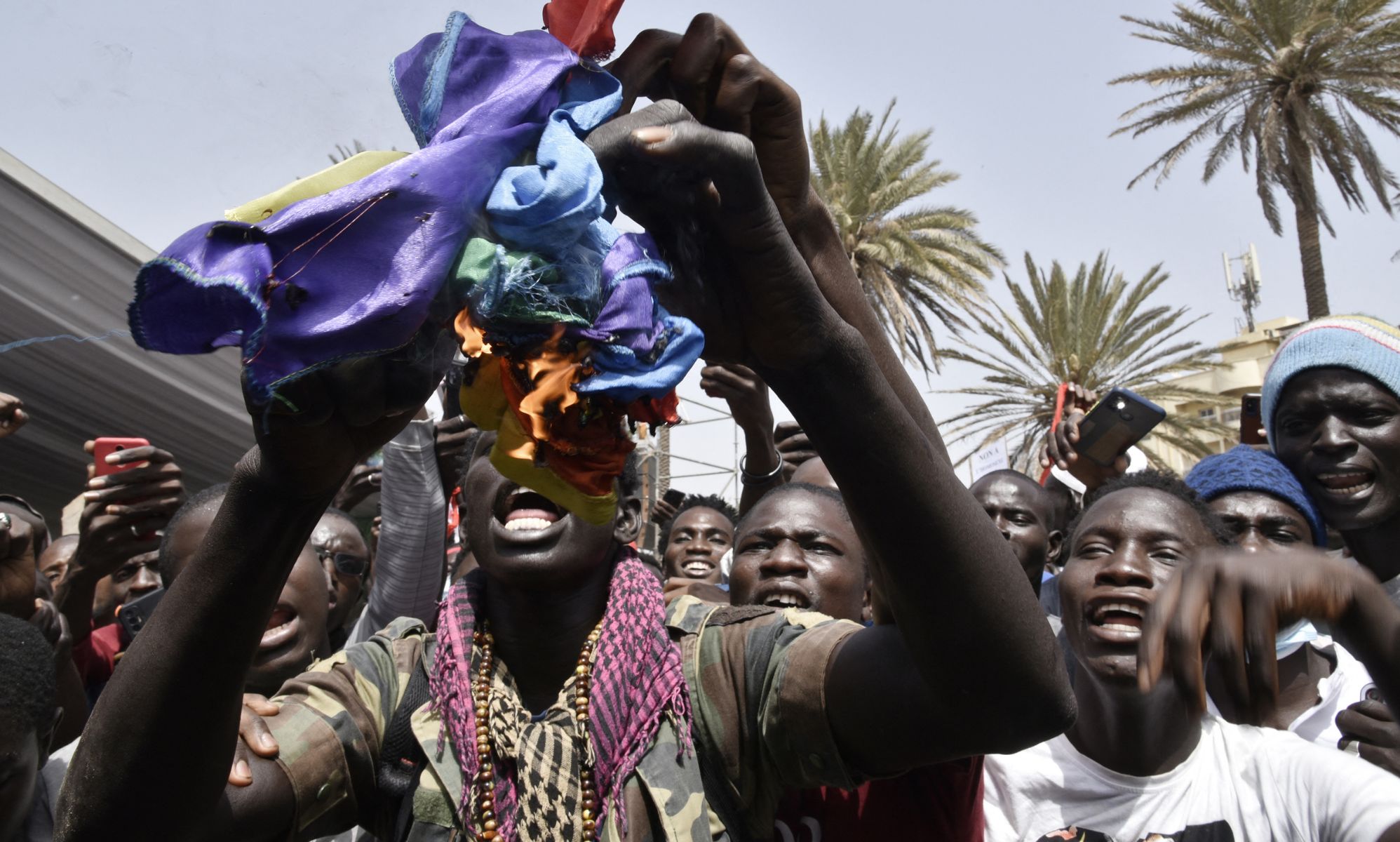 Protestors in Senegal ripping up an LGBTQ+ Pride flag.