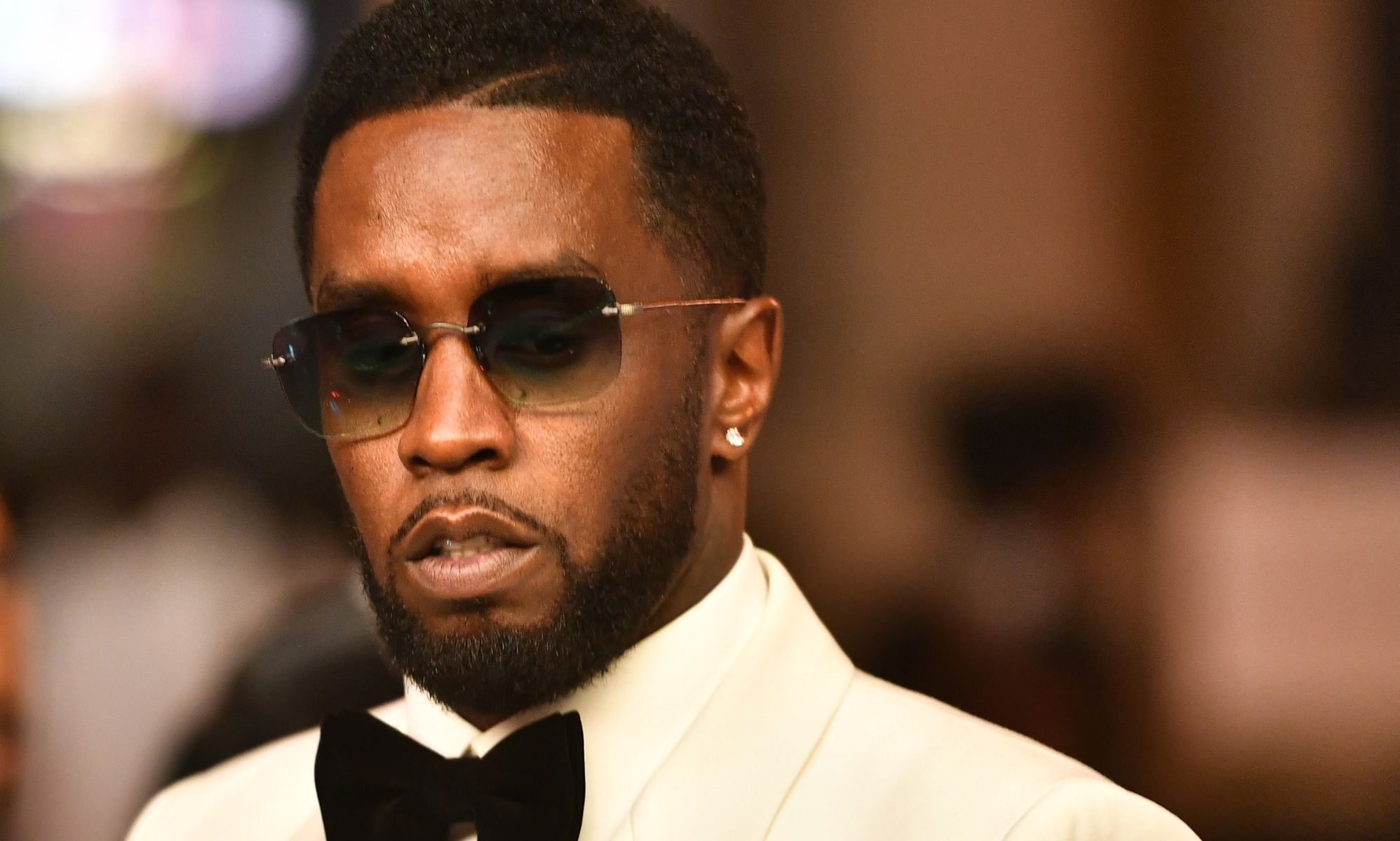 Sean Diddy Combs wearing a pair of sunglasses during an event.