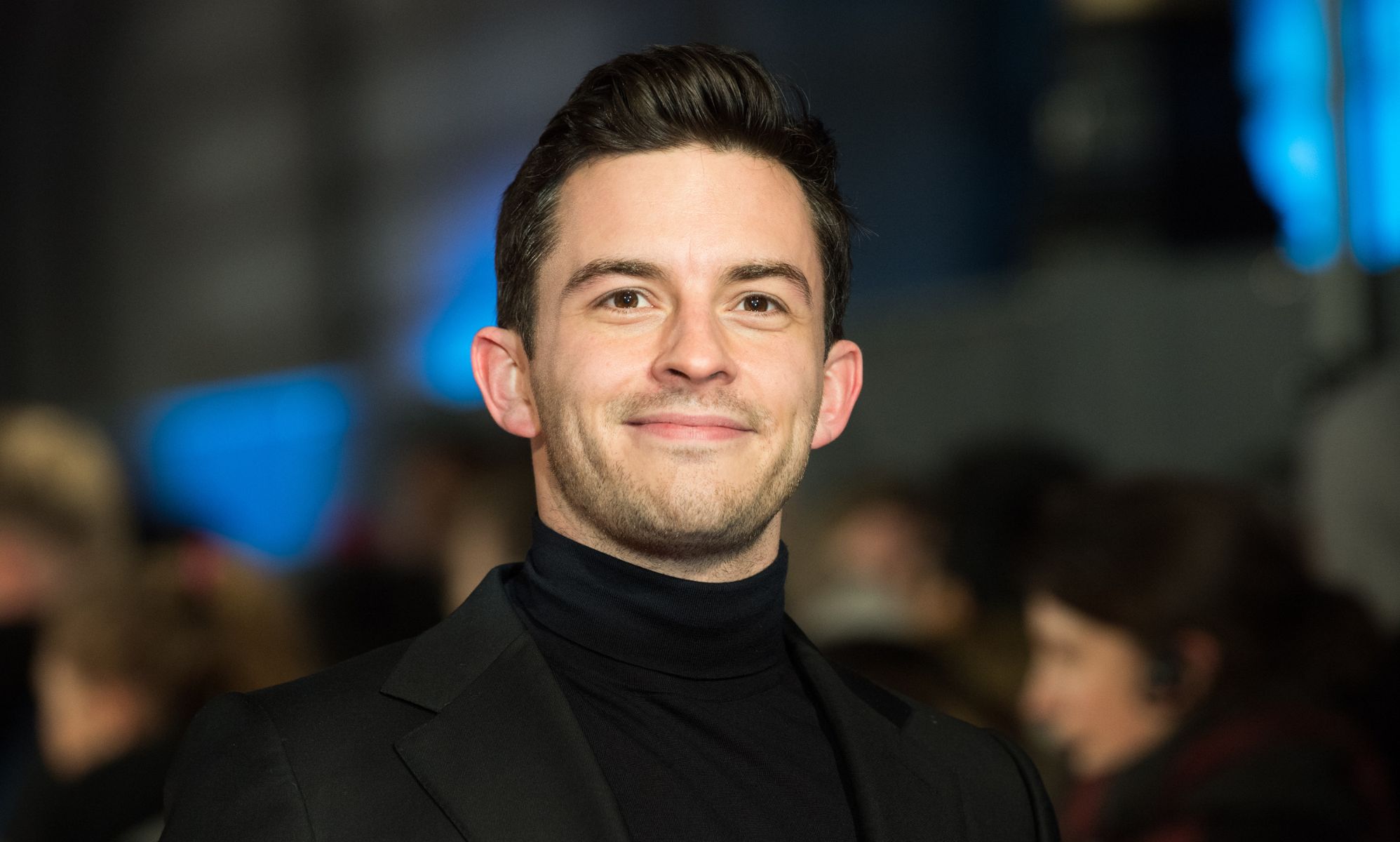 Jonathan Bailey in a black blazer and roll neck.