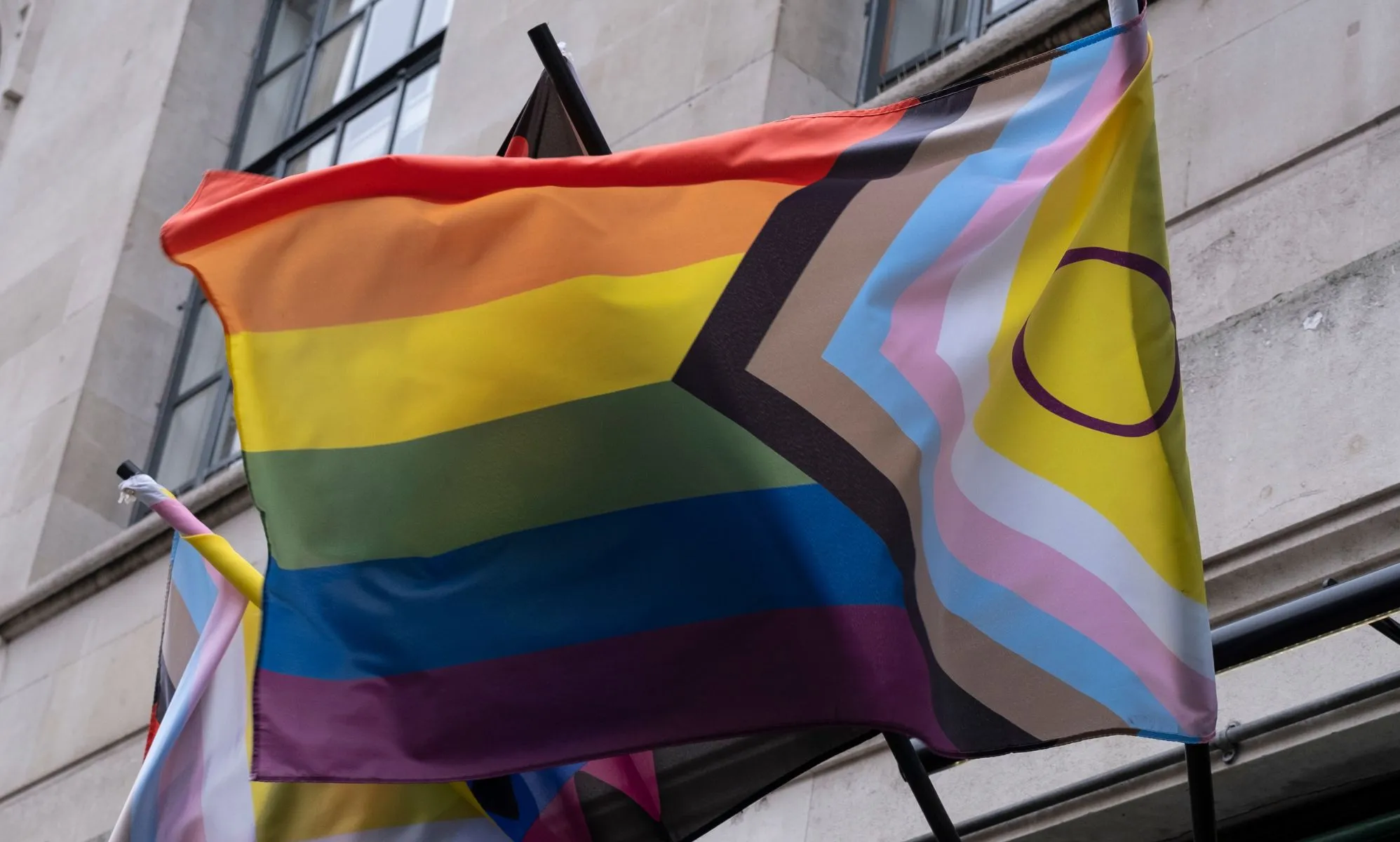 A Pride flag attached to a building.