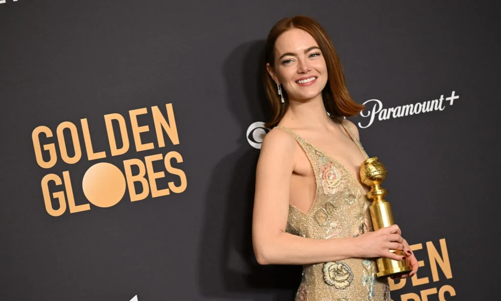 Emma Stone poses with the award for Best Performance by a Female Actor in a Motion Picture - Musical or Comedy for her performance in Poor Things