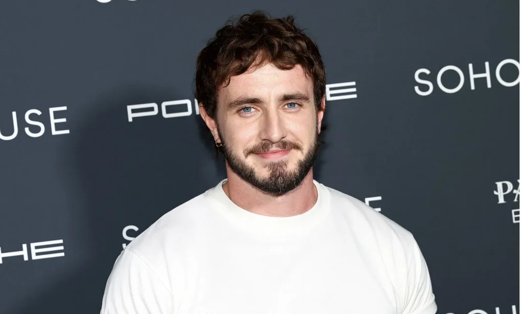 Paul Mescal smiling during a red carpet event.