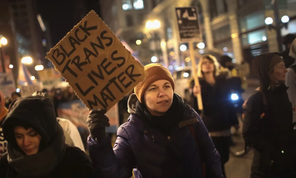 Protester holds up sign reading