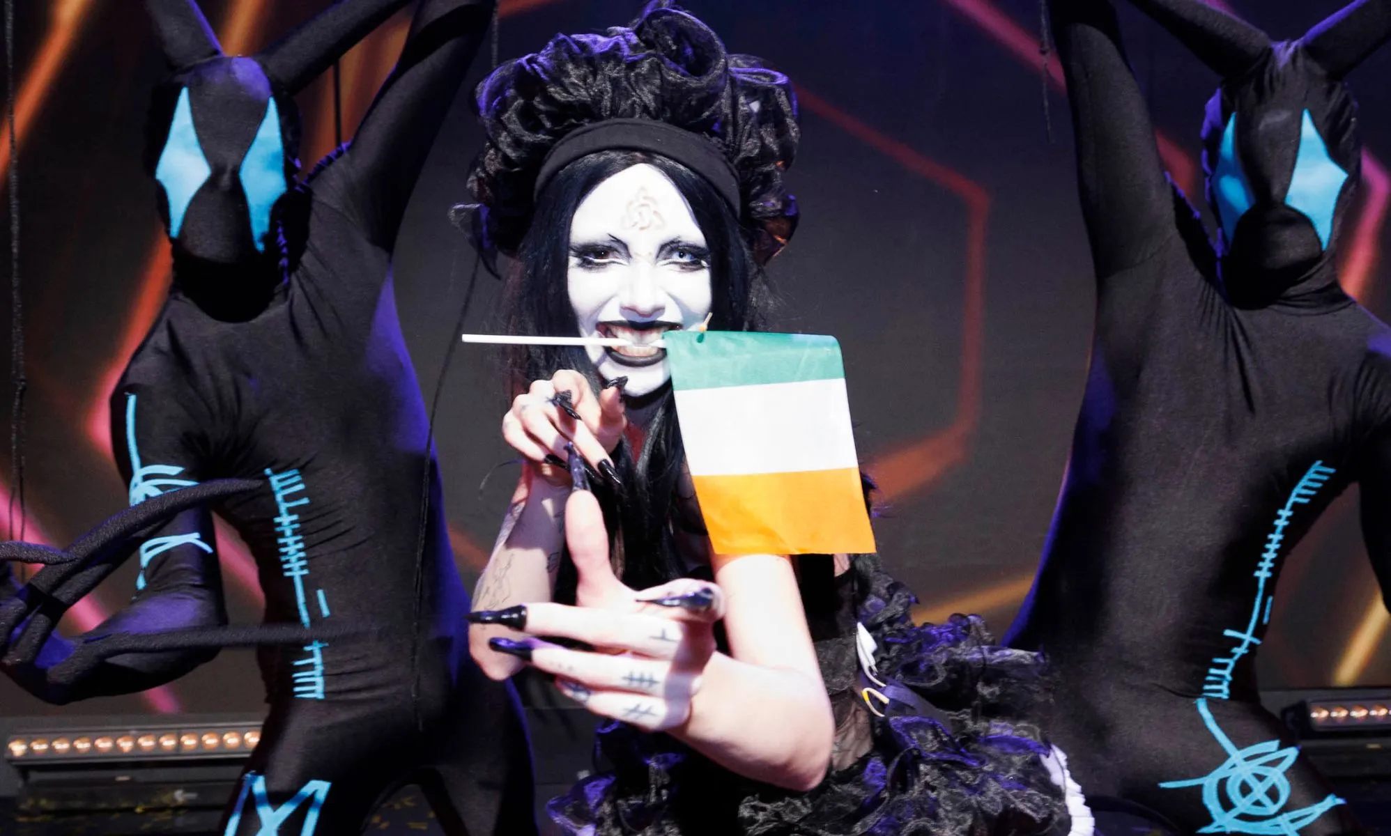 Bambie Thug performing with the Ireland flag in their mouth.