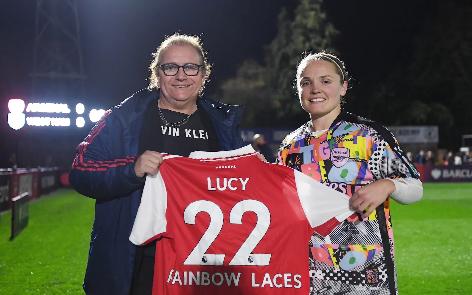 Lucy Clark is presented with a Rainbow Laces Arsenal home shirt by Kim Little, Captain of Arsenal prior to the Barclays FA Women