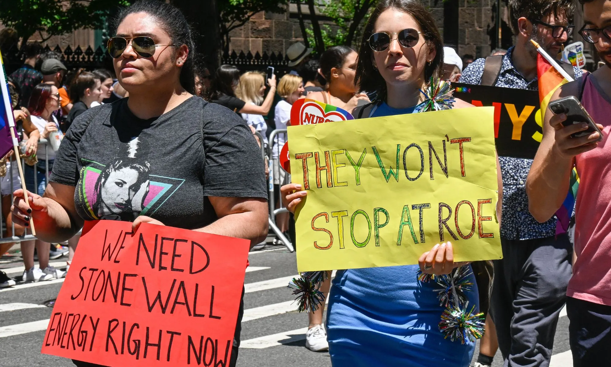 New York City Pride parade with one person holding a sign that says