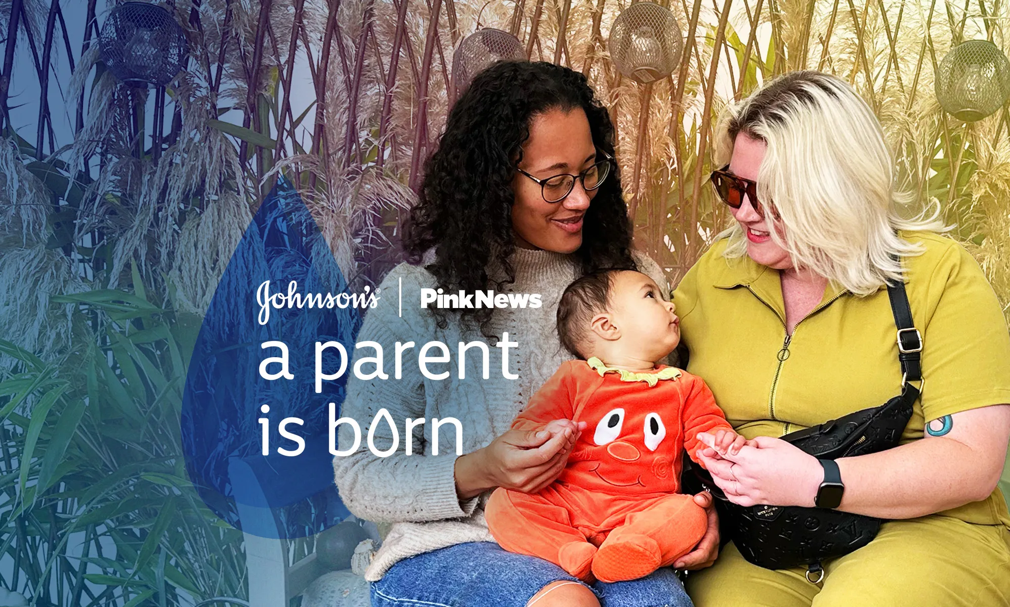 This is an image with 2 women holding a baby. The woman on the left is wearing a grey jumper. She has long dark hair and is wearing glasses. The woman on the right has bright blonde hair and is wearing sunglasses. The baby in the middle is wearing an orange onesie. Over the image in white text reads "JOHNSON