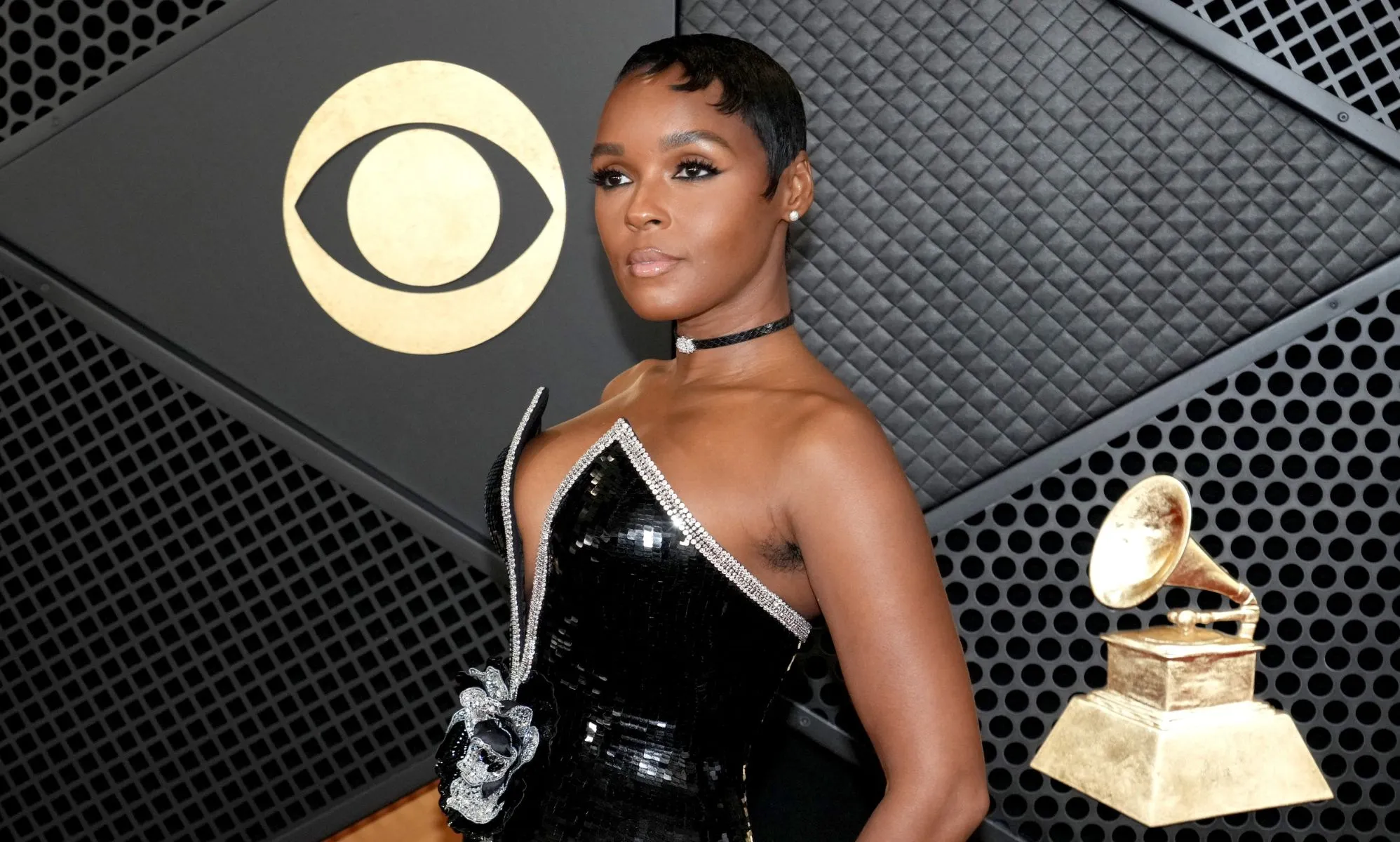 Janelle Monáe wearing a black and silver dress at the 2024 Grammys